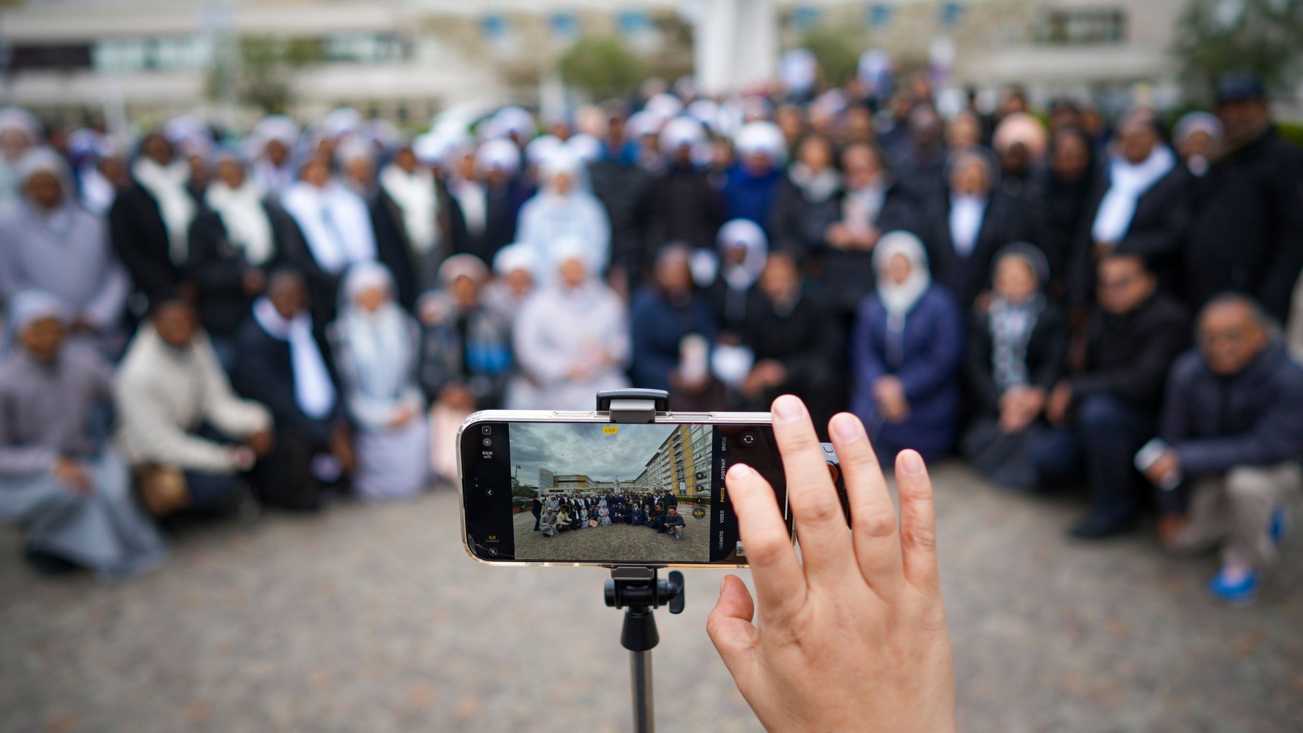 Nuns have a group photo taken at the end of a prayer for Pope Francis in front of the Agostino Gemelli Polyclinic, in Rome, Sunday, March 9, 2025. (AP Photo/Andrew Medichini)