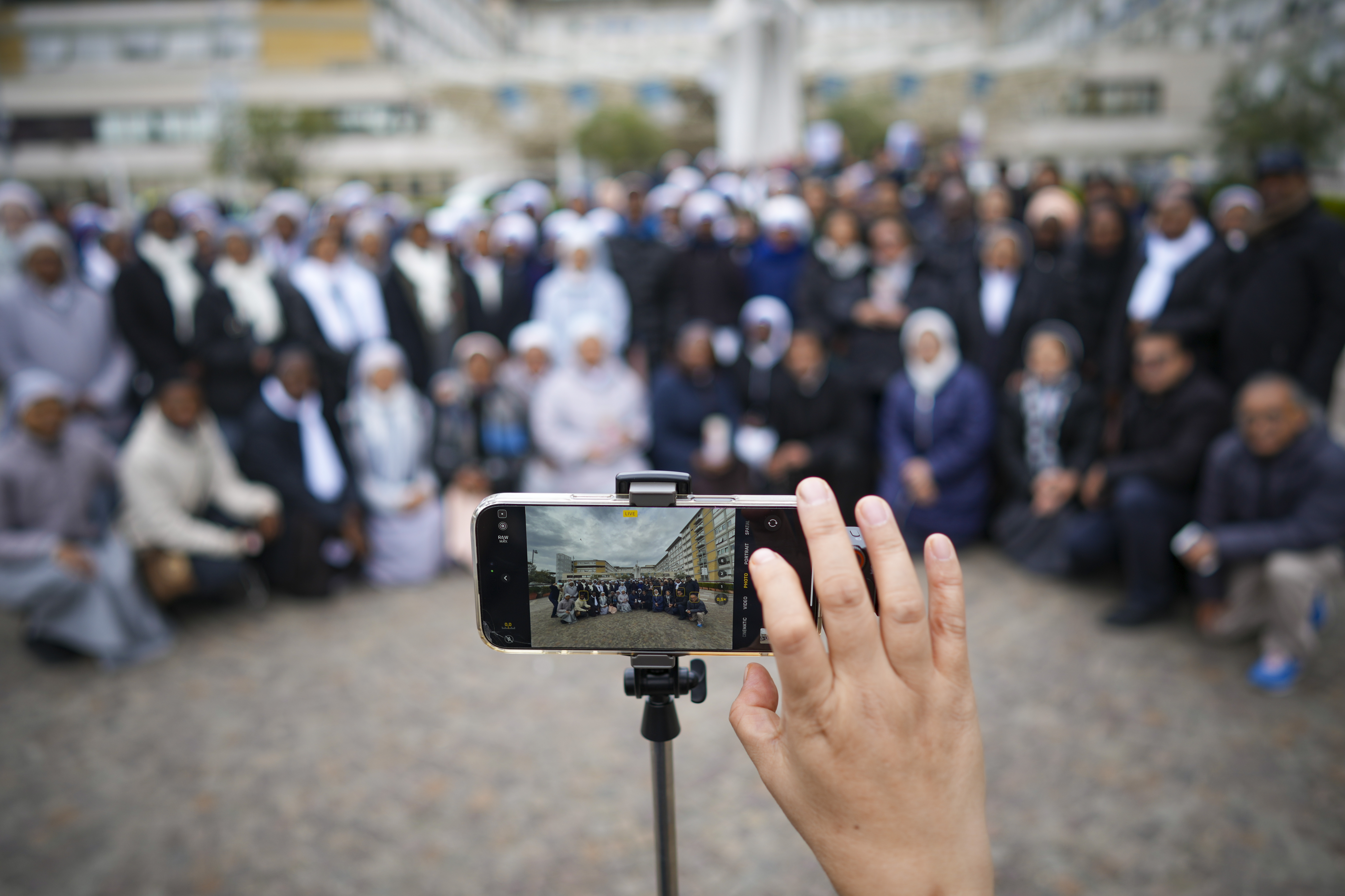 Nuns have a group photo taken at the end of a prayer for Pope Francis in front of the Agostino Gemelli Polyclinic, in Rome, Sunday, March 9, 2025. (AP Photo/Andrew Medichini)