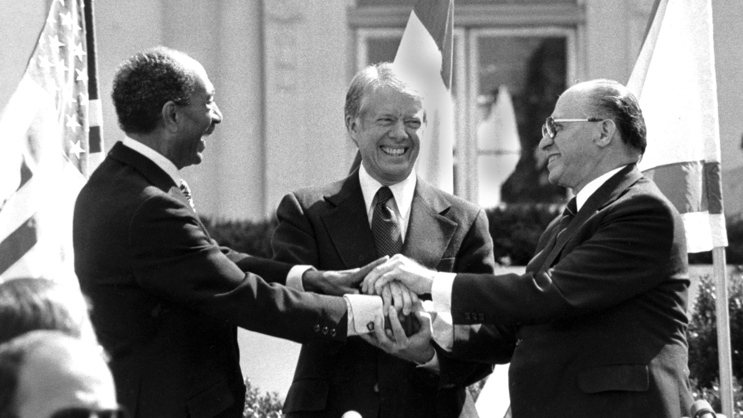 FILE - Egyptian President Anwar Sadat, left, U.S. President Jimmy Carter, center, and Israeli Prime Minister Menachem Begin clasp hands on the north lawn of the White House after signing the peace treaty between Egypt and Israel, March 26, 1979, in Washington. (AP Photo/ Bob Daugherty, File)