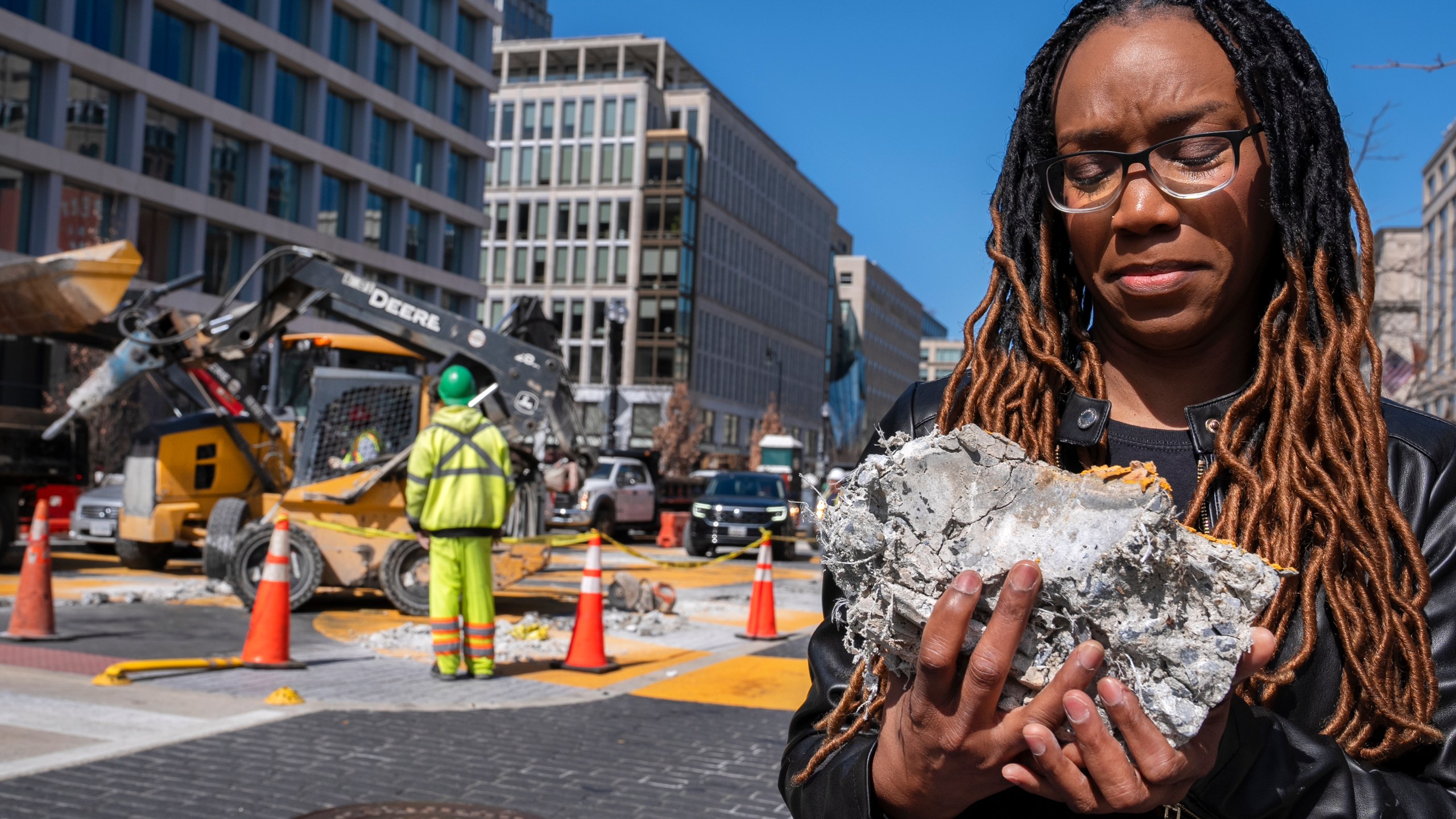 Tears roll down the face of Starlette Thomas, of Bowie, Md., as she holds a chunk of pavement from the Black Lives Matter mural, Monday, March 10, 2025, as the mural begins to be demolished in Washington. "I needed to be here to bear witness," says Thomas, who was present at the 2020 George Floyd protests. "For me the Black Lives Matter sign etched in stone was a declaration of somebodyness and to watch it be undone in this way was very hurtful. To walk away with a piece of that, it means it's not gone. It's more than brick and mortar." (AP Photo/Jacquelyn Martin)