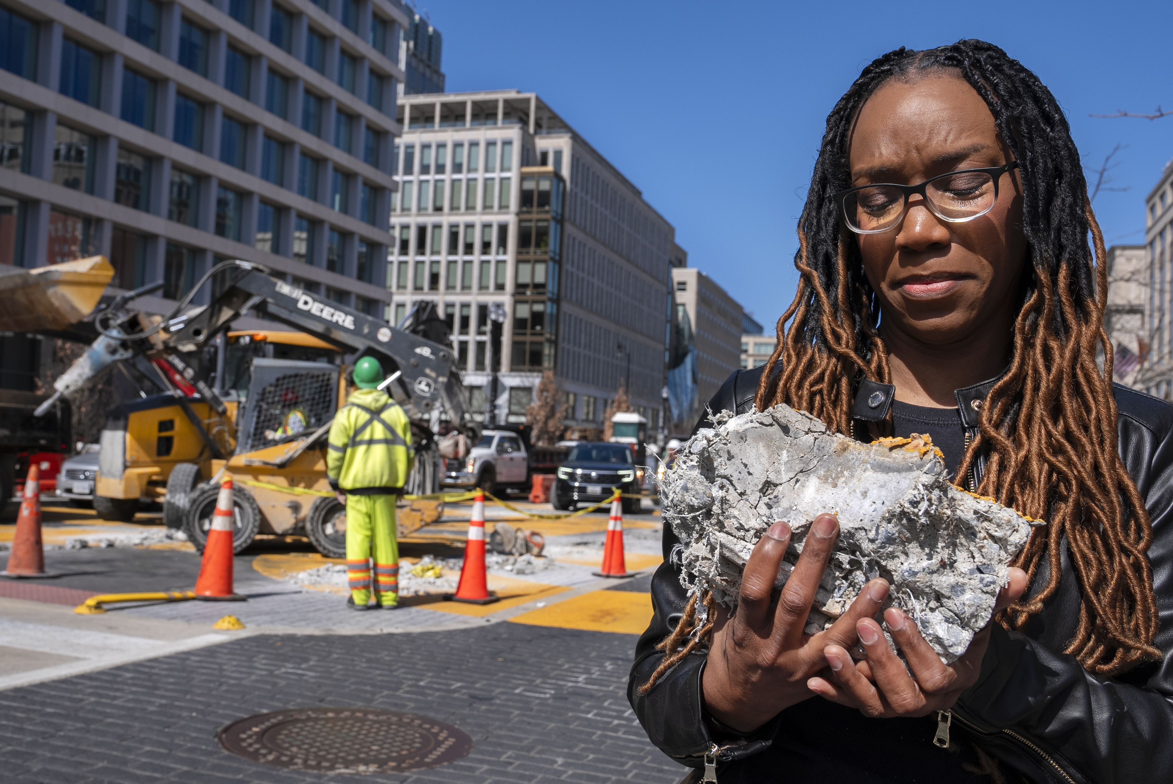 Tears roll down the face of Starlette Thomas, of Bowie, Md., as she holds a chunk of pavement from the Black Lives Matter mural, Monday, March 10, 2025, as the mural begins to be demolished in Washington. "I needed to be here to bear witness," says Thomas, who was present at the 2020 George Floyd protests. "For me the Black Lives Matter sign etched in stone was a declaration of somebodyness and to watch it be undone in this way was very hurtful. To walk away with a piece of that, it means it's not gone. It's more than brick and mortar." (AP Photo/Jacquelyn Martin)