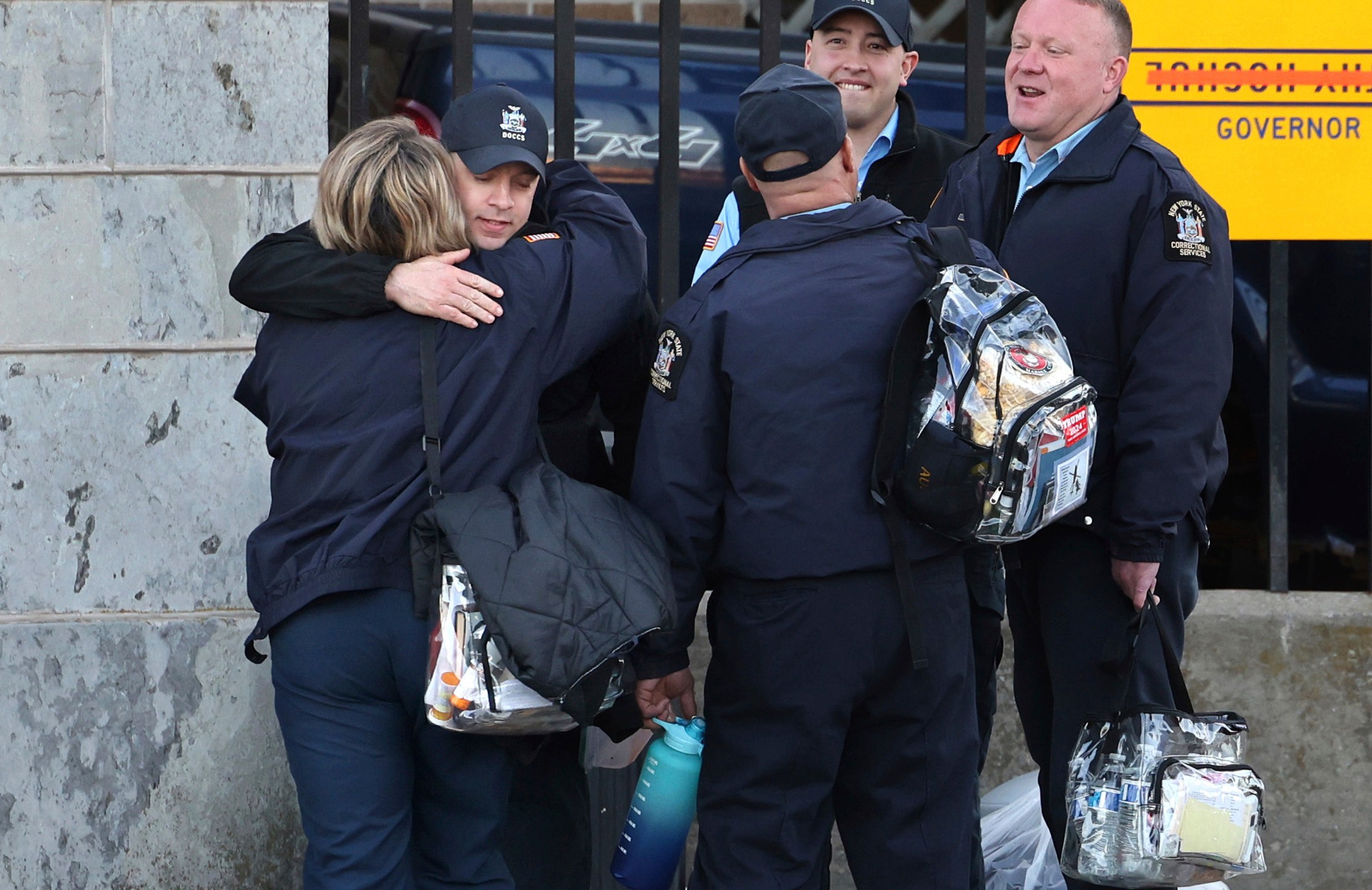 Correction officers greet each other during a shift change at Auburn Correctional Facility in Auburn, N.Y., on the first day back to work after the strike ended Monday, March 10, 2025. (Kevin Rivoli/The Citizen via AP)