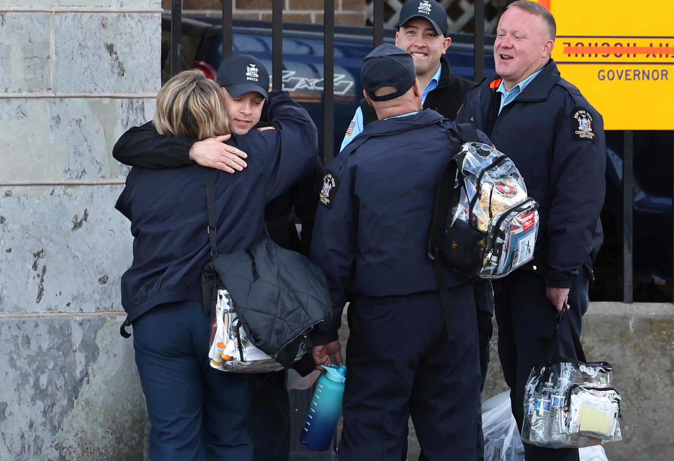 Correction officers greet each other during a shift change at Auburn Correctional Facility in Auburn, N.Y., on the first day back to work after the strike ended Monday, March 10, 2025. (Kevin Rivoli/The Citizen via AP)