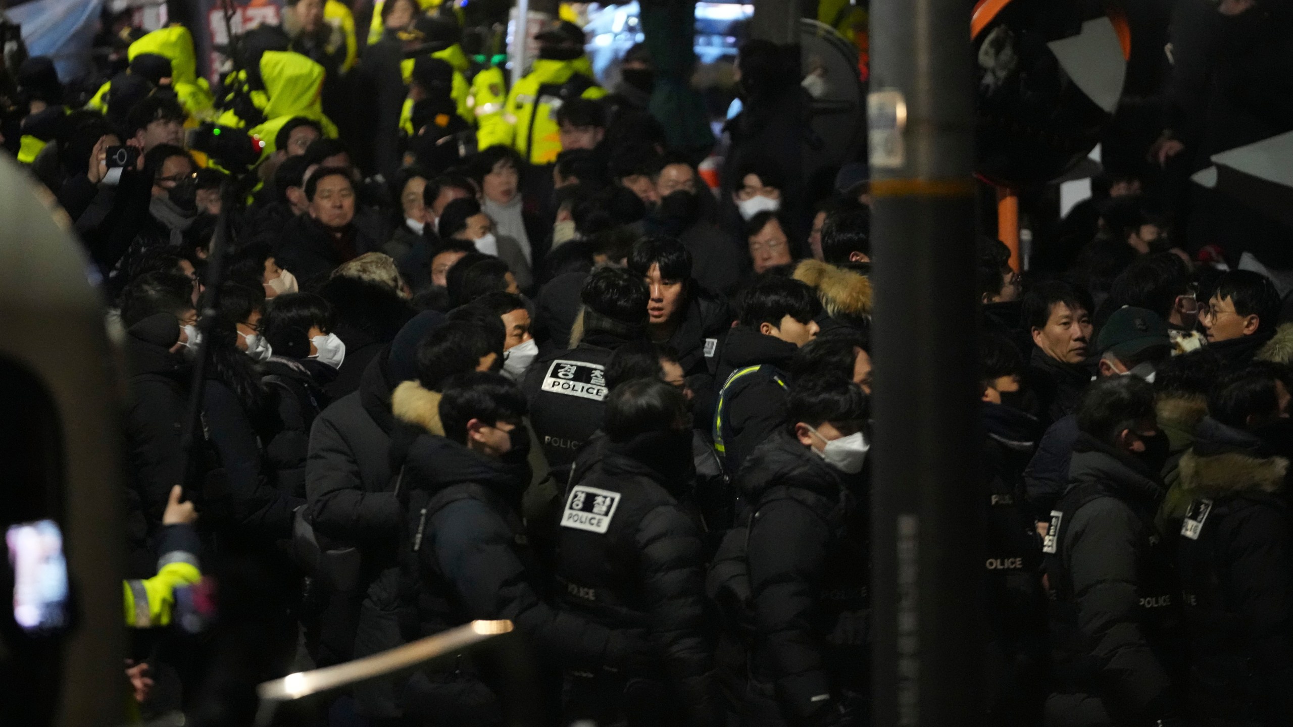 FILE - Police officers try to enter as the members of the ruling People Power Party try to block them in front of the gate of the presidential residence in Seoul, South Korea, on Jan. 15, 2025. (AP Photo/Lee Jin-man, File)