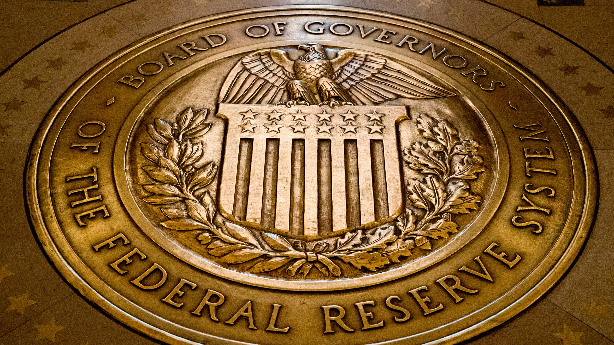 FILE - The seal of the Board of Governors of the United States Federal Reserve System is displayed in the ground at the Marriner S. Eccles Federal Reserve Board Building in Washington, Feb. 5, 2018. (AP Photo/Andrew Harnik, File)