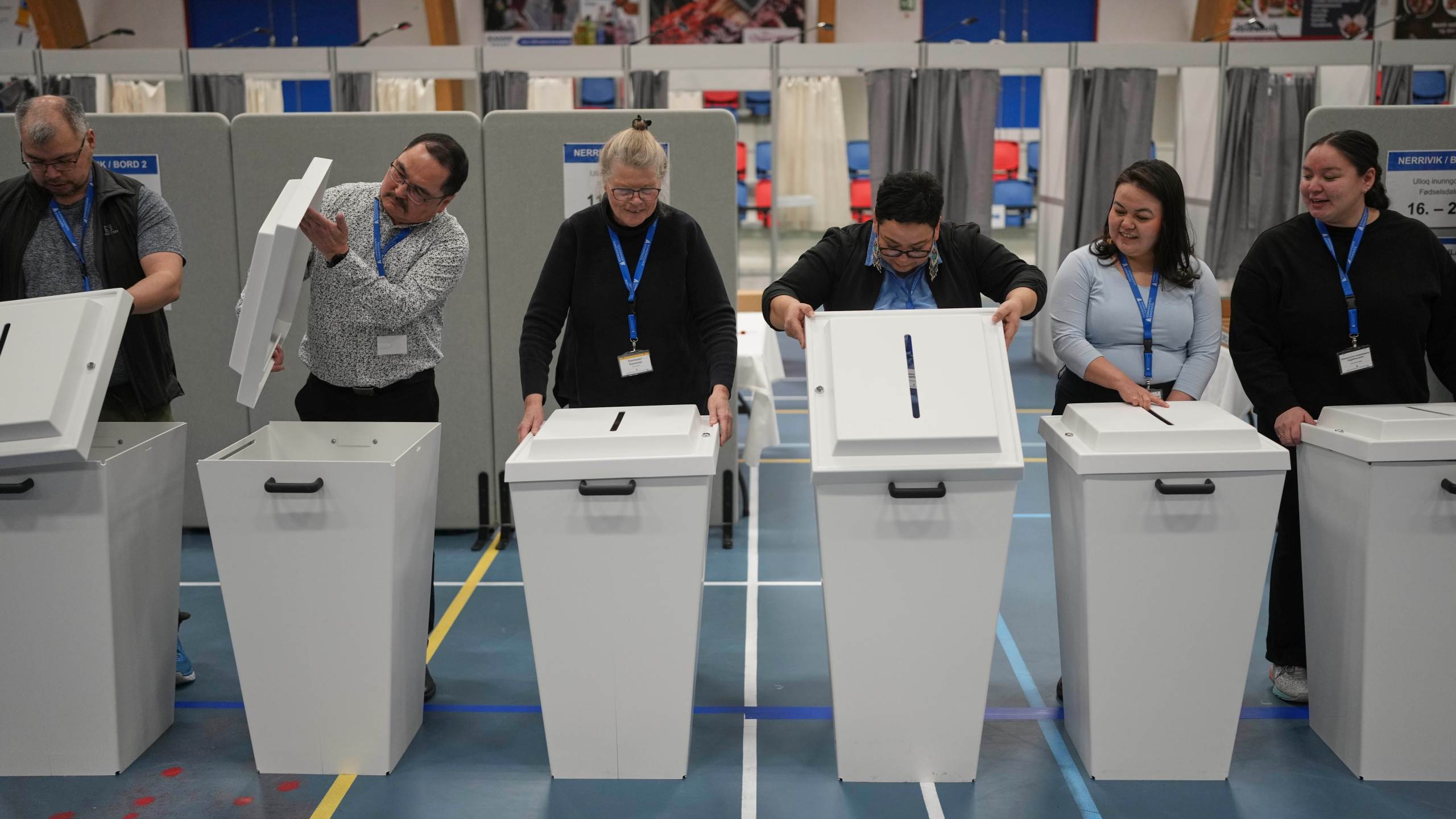 The election commission prepares ballot boxes for people to cast their vote in parliamentary elections, in Nuuk, Greenland, Tuesday, March 11, 2025. (AP Photo/Evgeniy Maloletka)