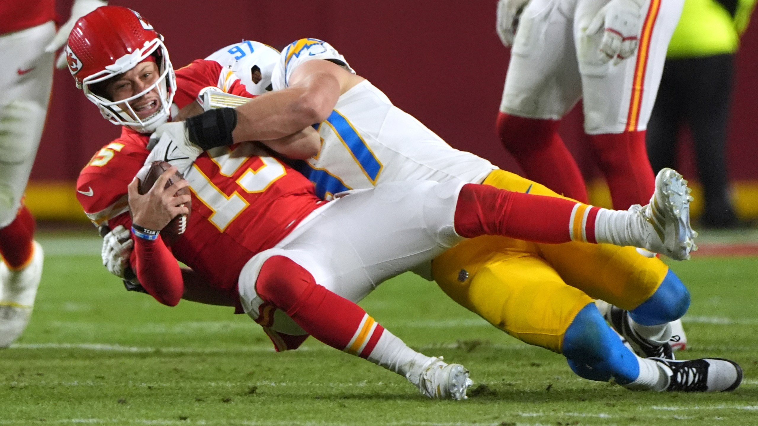 FILE - Kansas City Chiefs quarterback Patrick Mahomes, left, is sacked by Los Angeles Chargers linebacker Joey Bosa during the first half of an NFL football game, Dec. 8, 2024, in Kansas City, Mo. (AP Photo/Charlie Riedel, File)