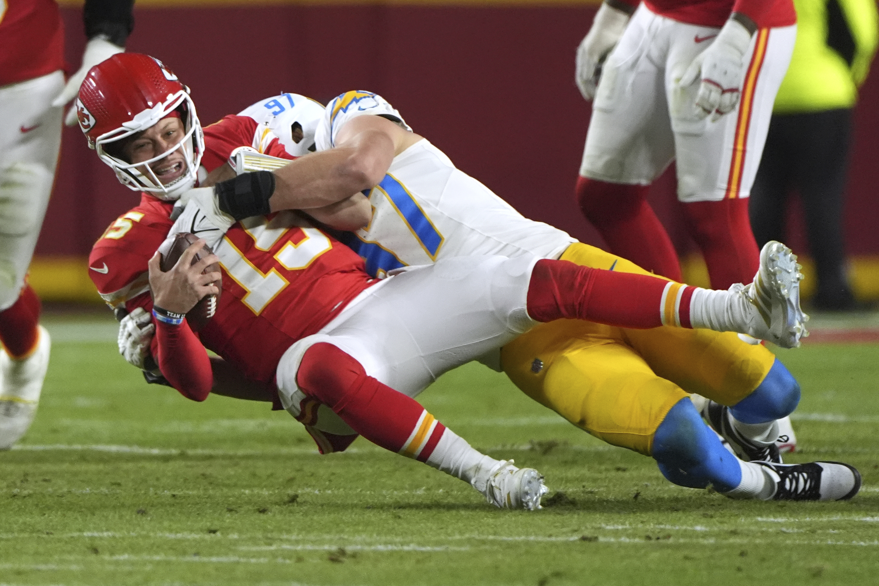 FILE - Kansas City Chiefs quarterback Patrick Mahomes, left, is sacked by Los Angeles Chargers linebacker Joey Bosa during the first half of an NFL football game, Dec. 8, 2024, in Kansas City, Mo. (AP Photo/Charlie Riedel, File)