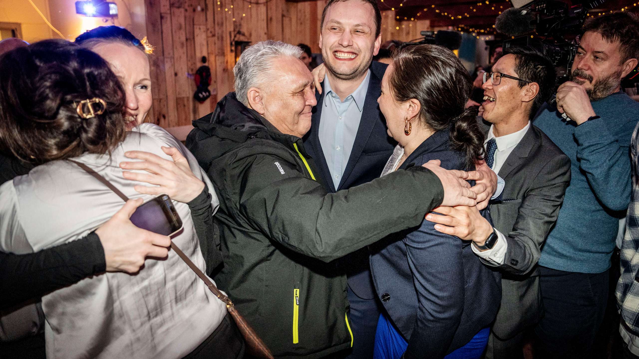 Chairman of Demokraatit, Jens-Frederik Nielsen, center, celebrates during the election party at Demokraatit by cafe Killut in Nuuk, early Wednesday, March 12, 2025. (Mads Claus Rasmussen/Ritzau Scanpix via AP)