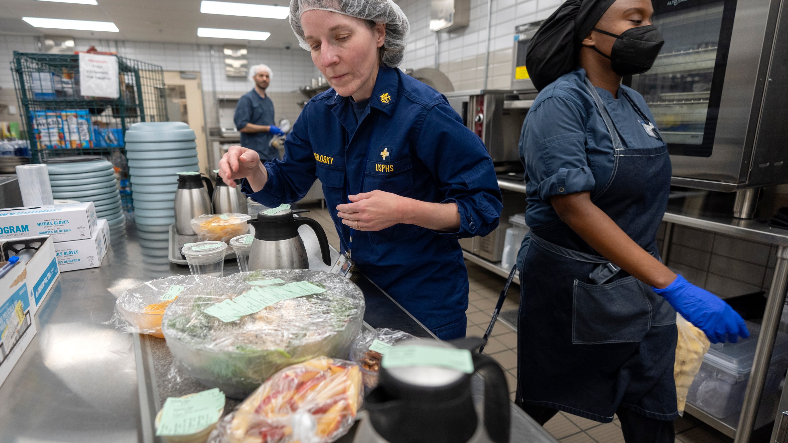 From left, cook Jeff Tait, nutrition research manager Merel Kozlosky, and research dietitian Sharonne Waters prepare a meal for college student and research subject Sam Srisatta in a kitchen as part of a study on the health effects of ultraprocessed foods at the National Institutes of Health in Bethesda, Md., on Thursday, Oct. 31, 2024. (AP Photo/Mark Schiefelbein)