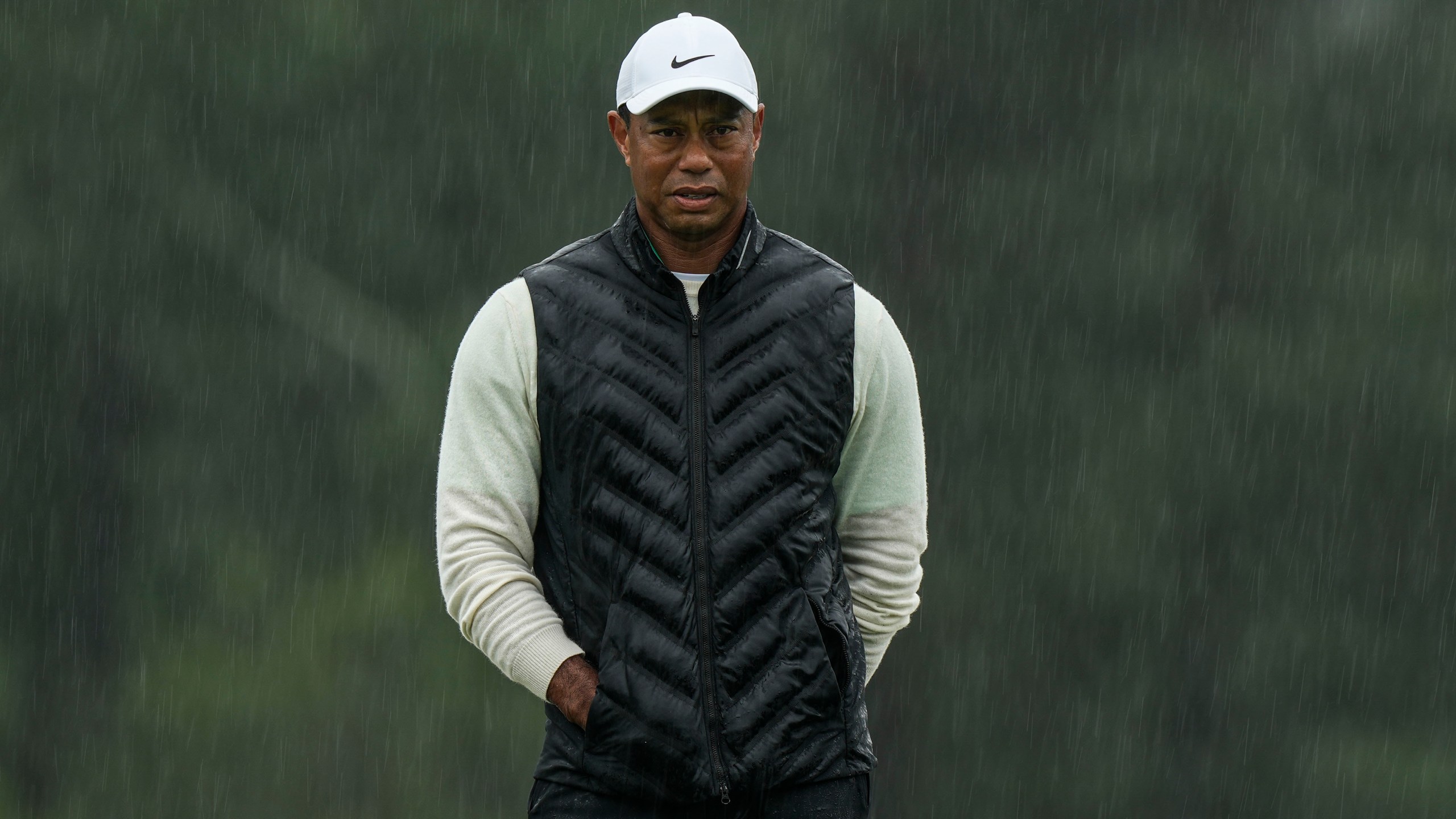 FILE - Tiger Woods walks on the 18th hole during the weather delayed second round of the Masters golf tournament at Augusta National Golf Club on April 8, 2023, in Augusta, Ga. (AP Photo/Charlie Riedel, file)