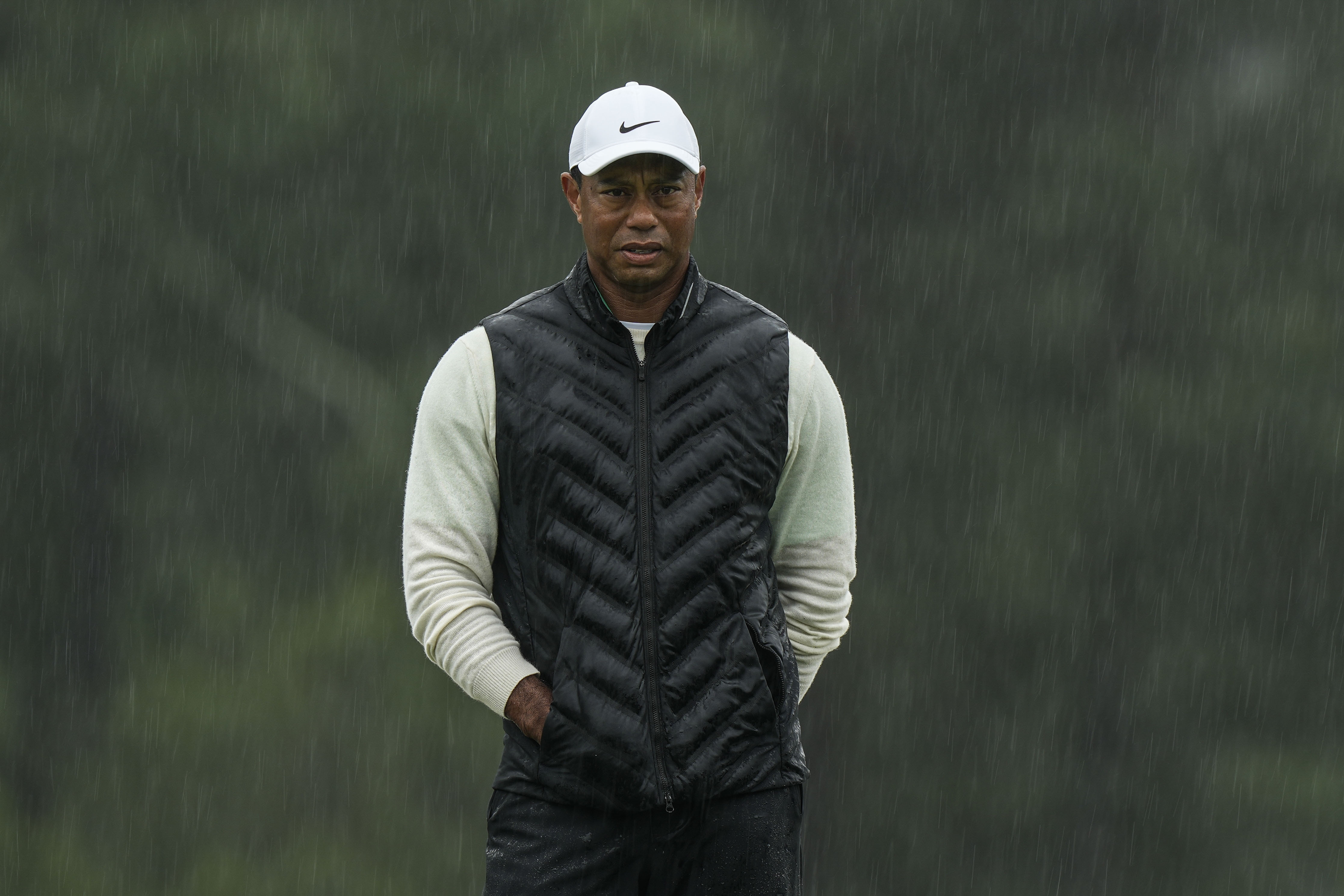 FILE - Tiger Woods walks on the 18th hole during the weather delayed second round of the Masters golf tournament at Augusta National Golf Club on April 8, 2023, in Augusta, Ga. (AP Photo/Charlie Riedel, file)