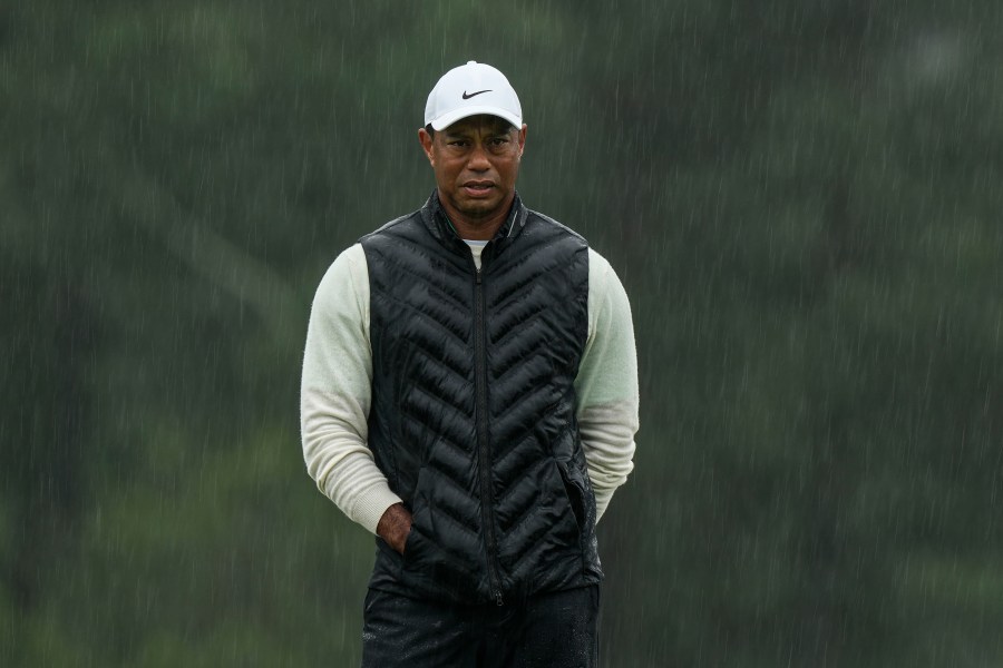 FILE - Tiger Woods walks on the 18th hole during the weather delayed second round of the Masters golf tournament at Augusta National Golf Club on April 8, 2023, in Augusta, Ga. (AP Photo/Charlie Riedel, file)