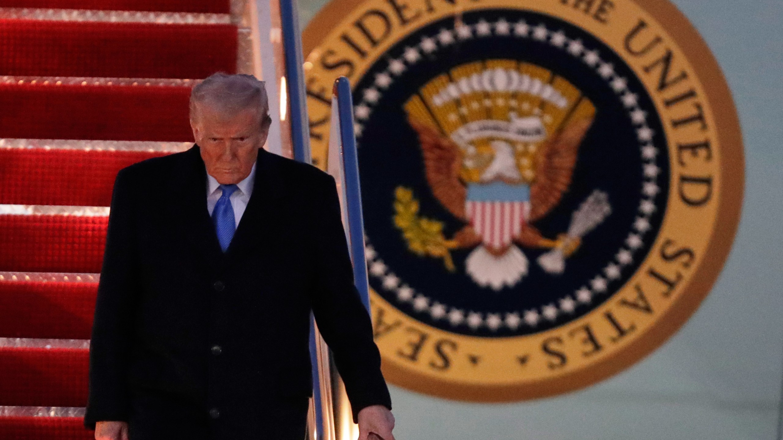 President Donald Trump walks down the stairs of Air Force One upon his arrival at Joint Base Andrews, Md., Sunday, March 9, 2025. (AP Photo/Luis M. Alvarez)