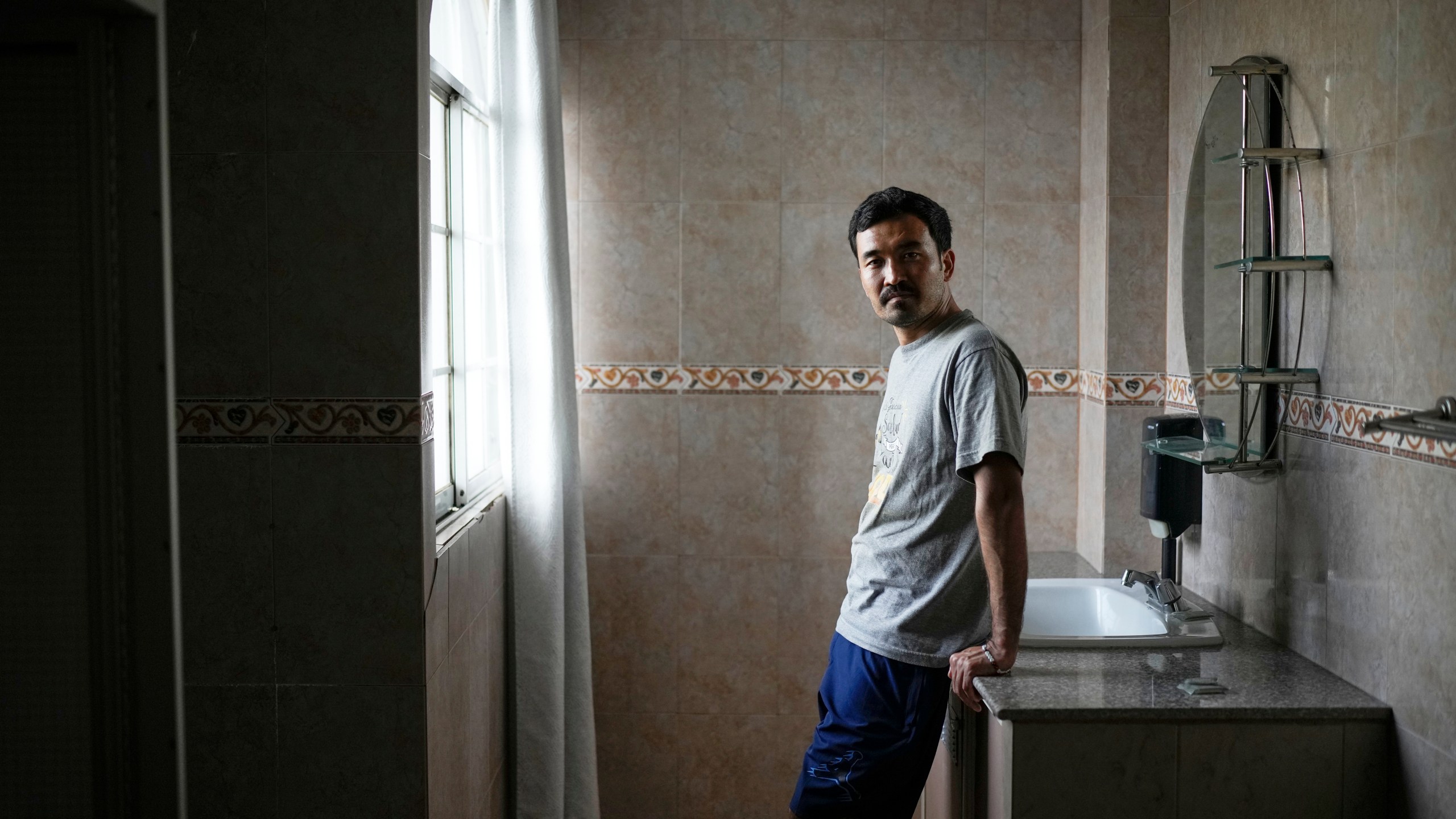 Afghan migrant Hayatullah Omagh poses for a portrait in Panama City, Monday, March 10, 2025, after being deported from the United States, detained for weeks in a Panamanian immigration camp and released on a temporary humanitarian visa allowing a 30‑day stay. (AP Photo/Matias Delacroix)