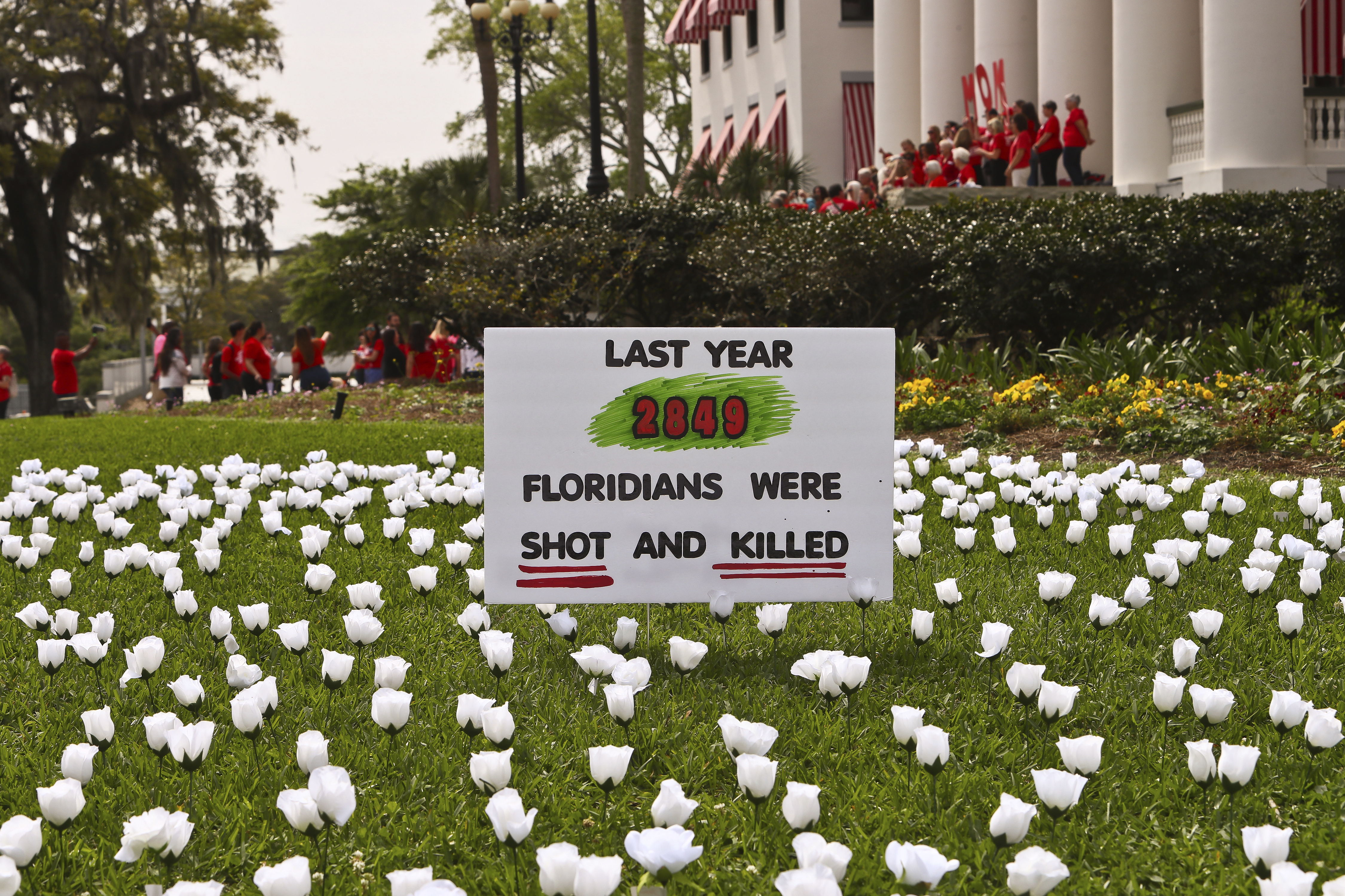 FILE - A sign and about 2,849 white silk roses, planted by South Florida members of Moms Demand Action to symbolize Floridians shot and killed last year, in front of the Old Capitol, March 9, 2023 at the Capitol in Tallahassee, Fla. (AP Photo/Phil Sears, file)