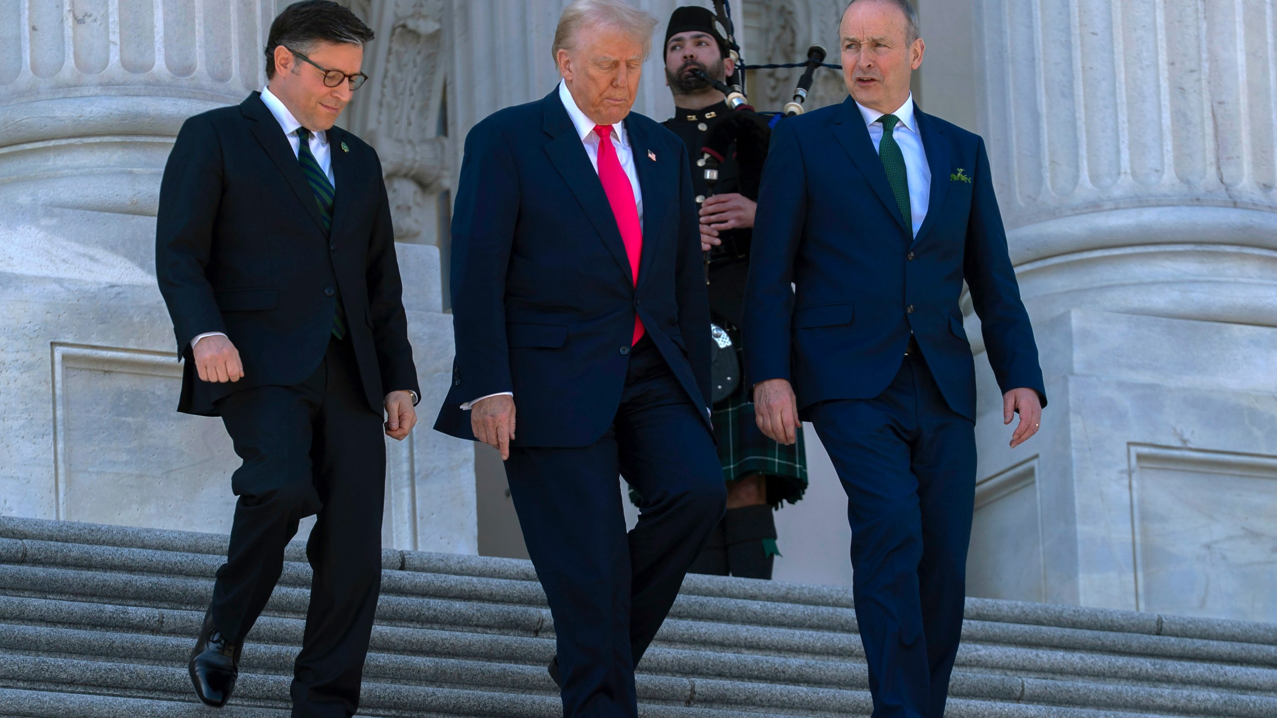 President Donald Trump, center, accompanied by Speaker of the House Mike Johnson, R-La., left, and Ireland's Prime Minister Micheal Martin, walks down the stairs of the U.S. Caopitol, after a luncheon on Wednesday, March 12, 2025, in Washington. (AP Photo/Jose Luis Magana)