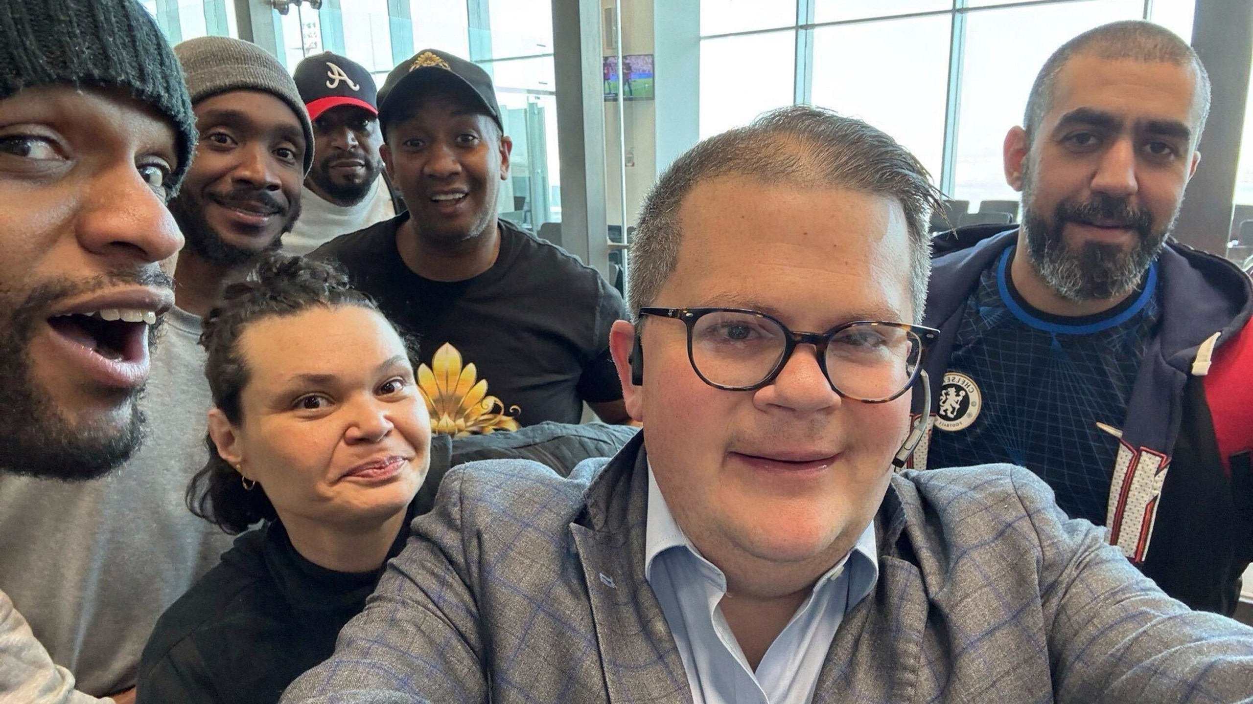 This image provided by Jonathan Franks shows Franks with six American prisoners detained by Kuwait as they pose for a photo at Kuwait International Airport Wednesday, March 12, 2025, before flying home to the United States. Franks is a private consultant who helped work for their release. (Jonathan Franks via AP)