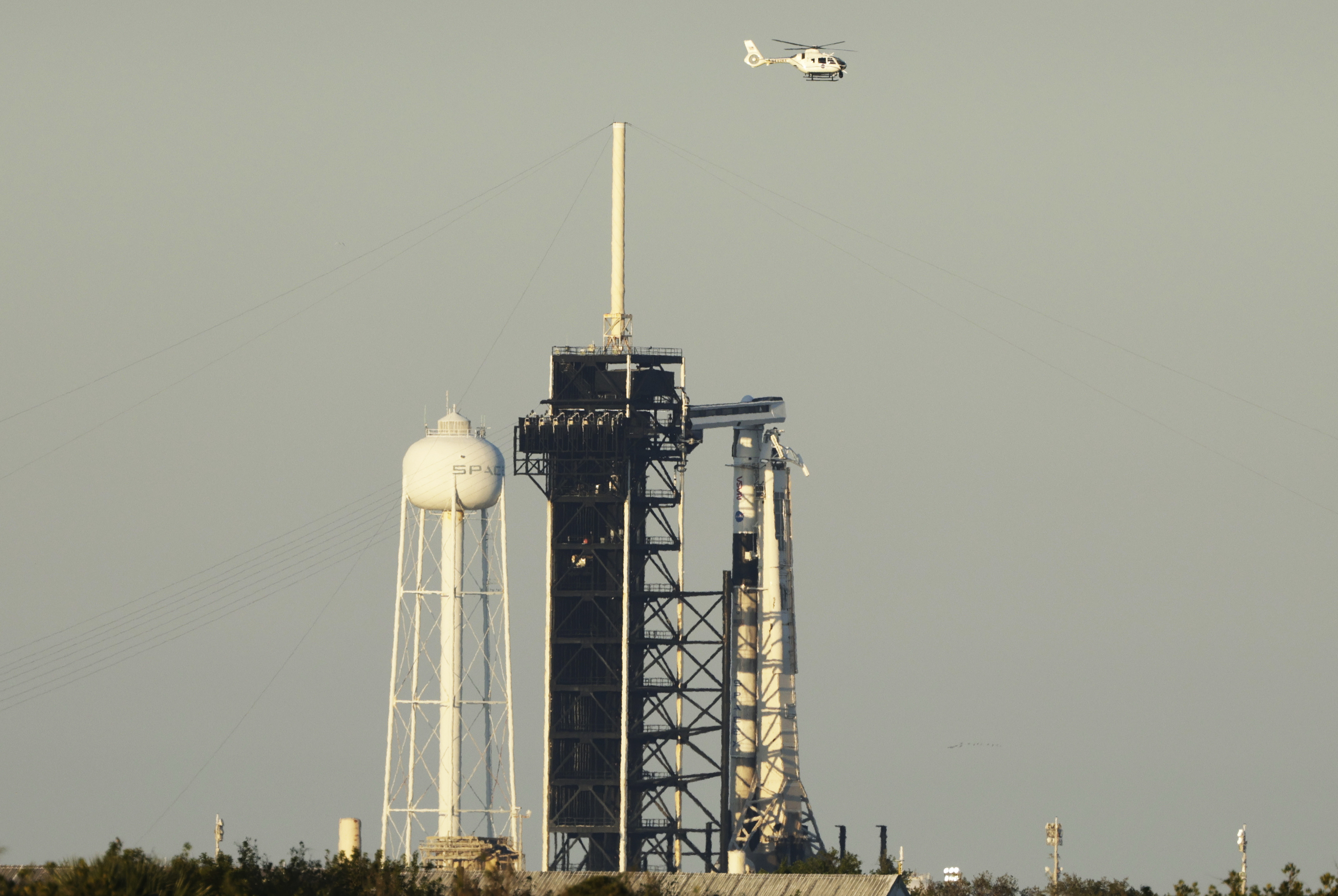 A SpaceX Falcon 9 rocket with a crew of four aboard the Crew Dragon spacecraft scrubbed prior to liftoff for a mission to the International Space Station from pad 39A at the Kennedy Space Center in Cape Canaveral, Fla., Wednesday, March 12, 2025. (AP Photo/Terry Renna)