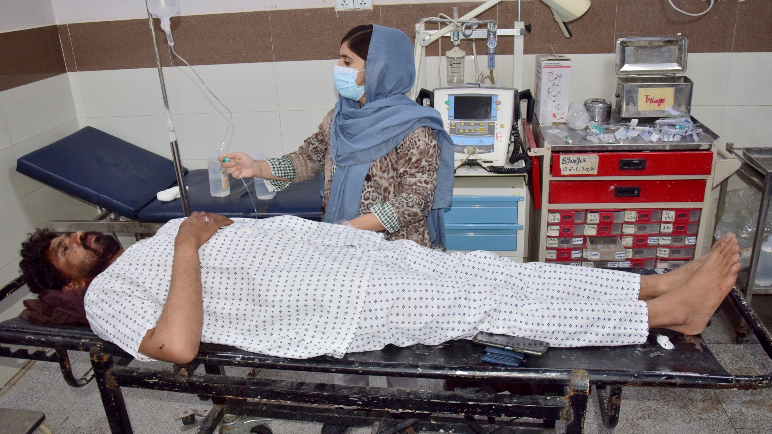 An injured victim of a passenger train attacked by insurgents, receives treatment upon arrival at a hospital in Quetta, Pakistan's southwestern Balochistan province, Thursday March 13, 2025. (AP Photo/Arshad Butt)