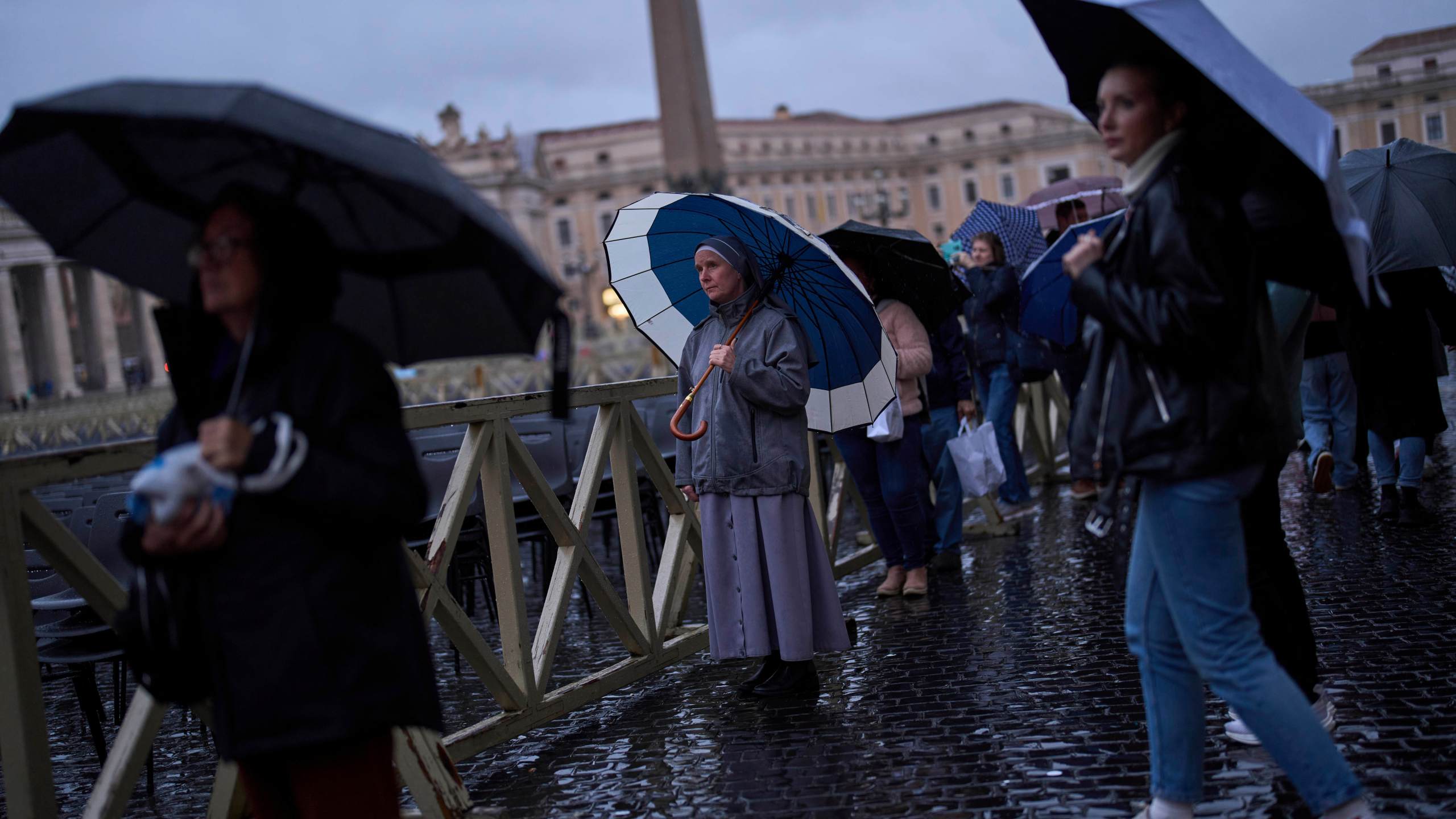 People pray as they follow a live broadcasted Rosary prayer for Pope Francis, in St. Peter's Square at the Vatican, Wednesday, March 12, 2025. (AP Photo/Francisco Seco)