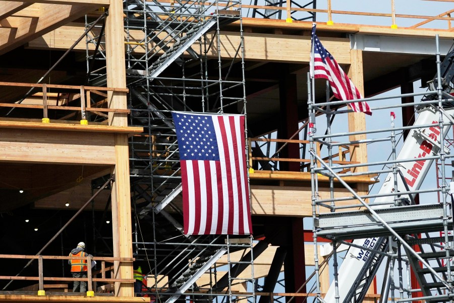 A construction crew works at a site in San Bruno, Calif., Wednesday, March 12, 2025. (AP Photo/Jeff Chiu)