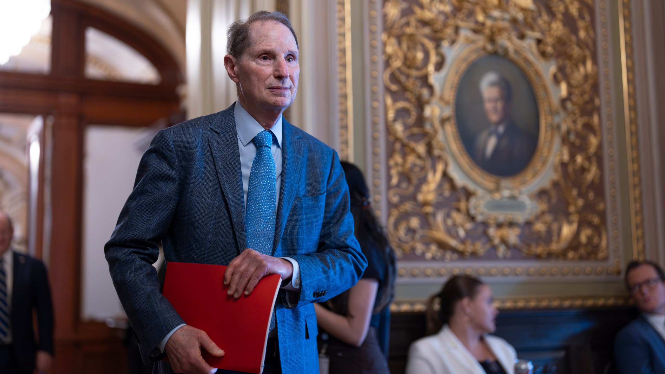 Sen. Ron Wyden, D-Ore., arrives as Senate Democrats gather behind closed doors to mount a last-ditch protest over a Republican-led spending bill that already passed the House, at the Capitol in Washington, Thursday, March 13, 2025. (AP Photo/J. Scott Applewhite)