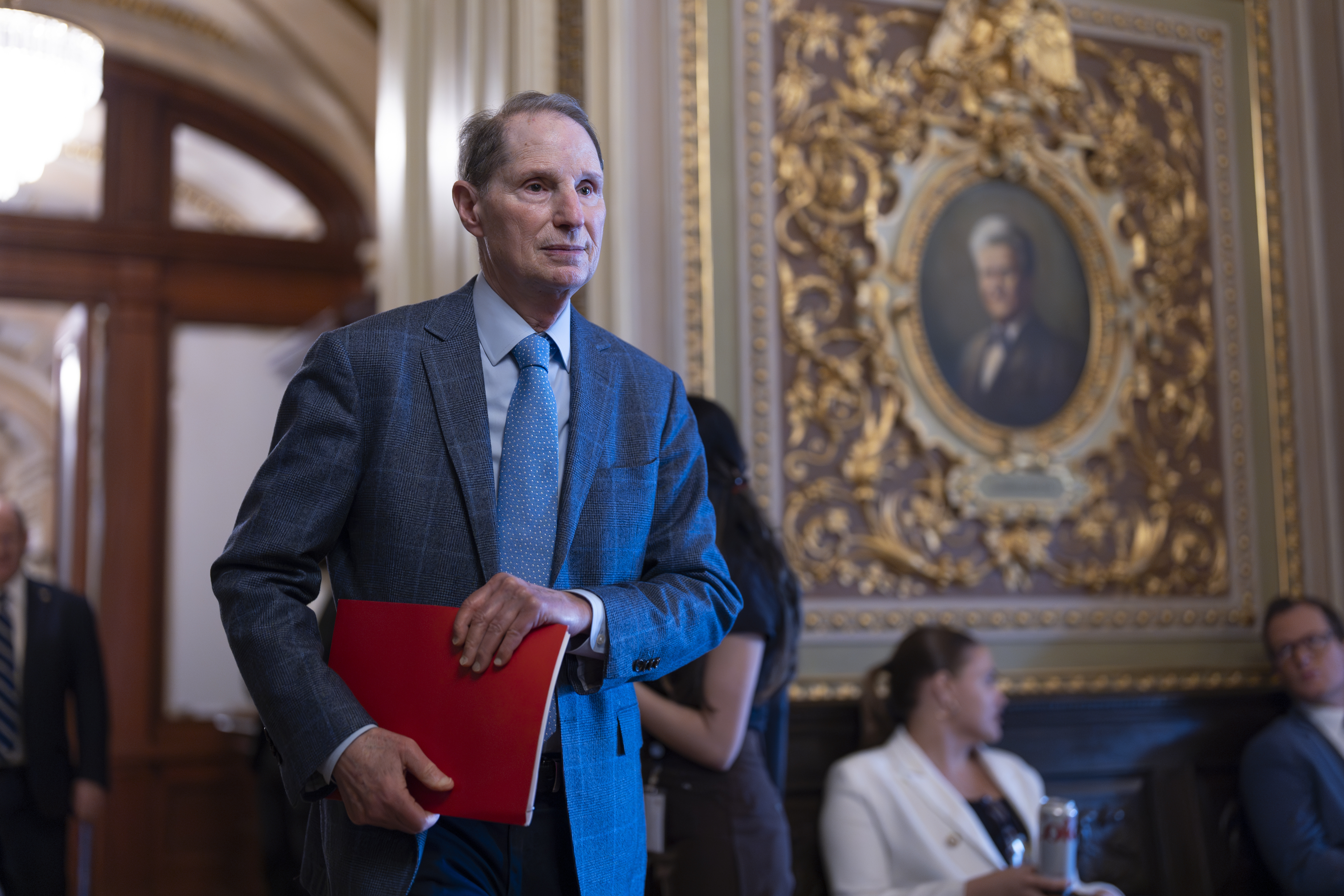 Sen. Ron Wyden, D-Ore., arrives as Senate Democrats gather behind closed doors to mount a last-ditch protest over a Republican-led spending bill that already passed the House, at the Capitol in Washington, Thursday, March 13, 2025. (AP Photo/J. Scott Applewhite)