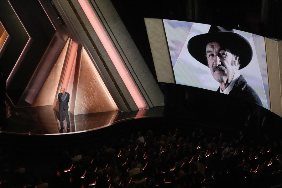 Morgan Freeman speaks about Gene Hackman with an image of Gene Hackman on the screen during the Oscars on Sunday, March 2, 2025, at the Dolby Theatre in Los Angeles. (AP Photo/Chris Pizzello)