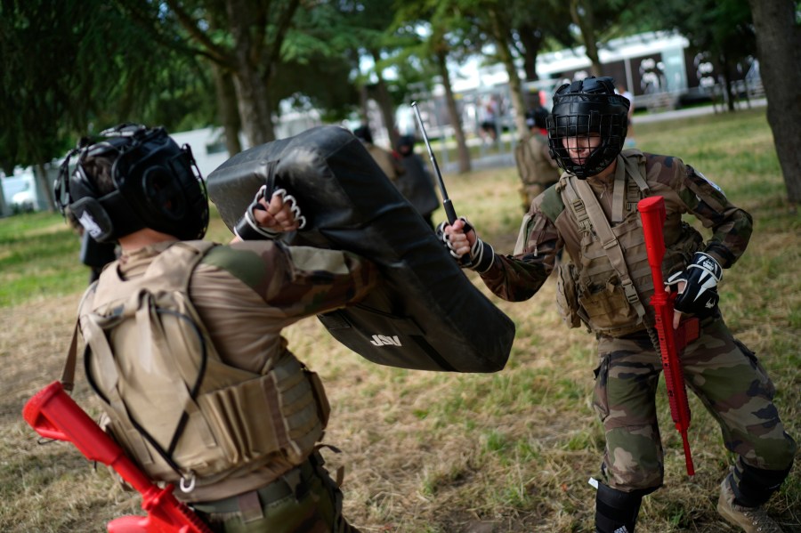 FILE - Soldiers demonstrate operational technics for close combat in a training class at a military camp set up for the Paris Olympic games, July 19, 2024, Vincennes, just outside Paris, France. (AP Photo/David Goldman, File)