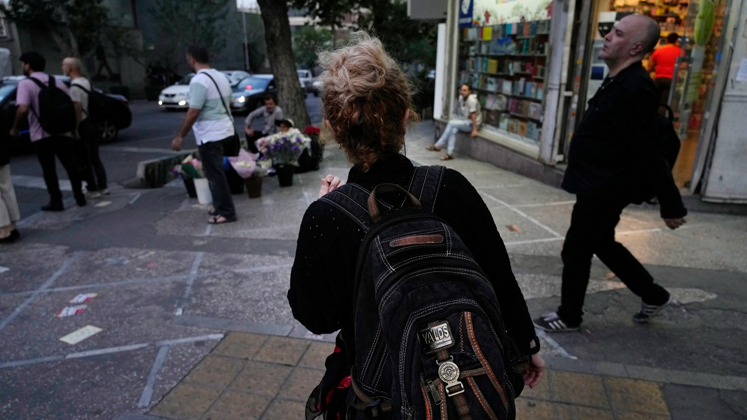 FILE - An Iranian woman, without a mandatory headscarf, or hijab, walks in downtown Tehran, Iran, June 10, 2024. (AP Photo/Vahid Salemi, File)