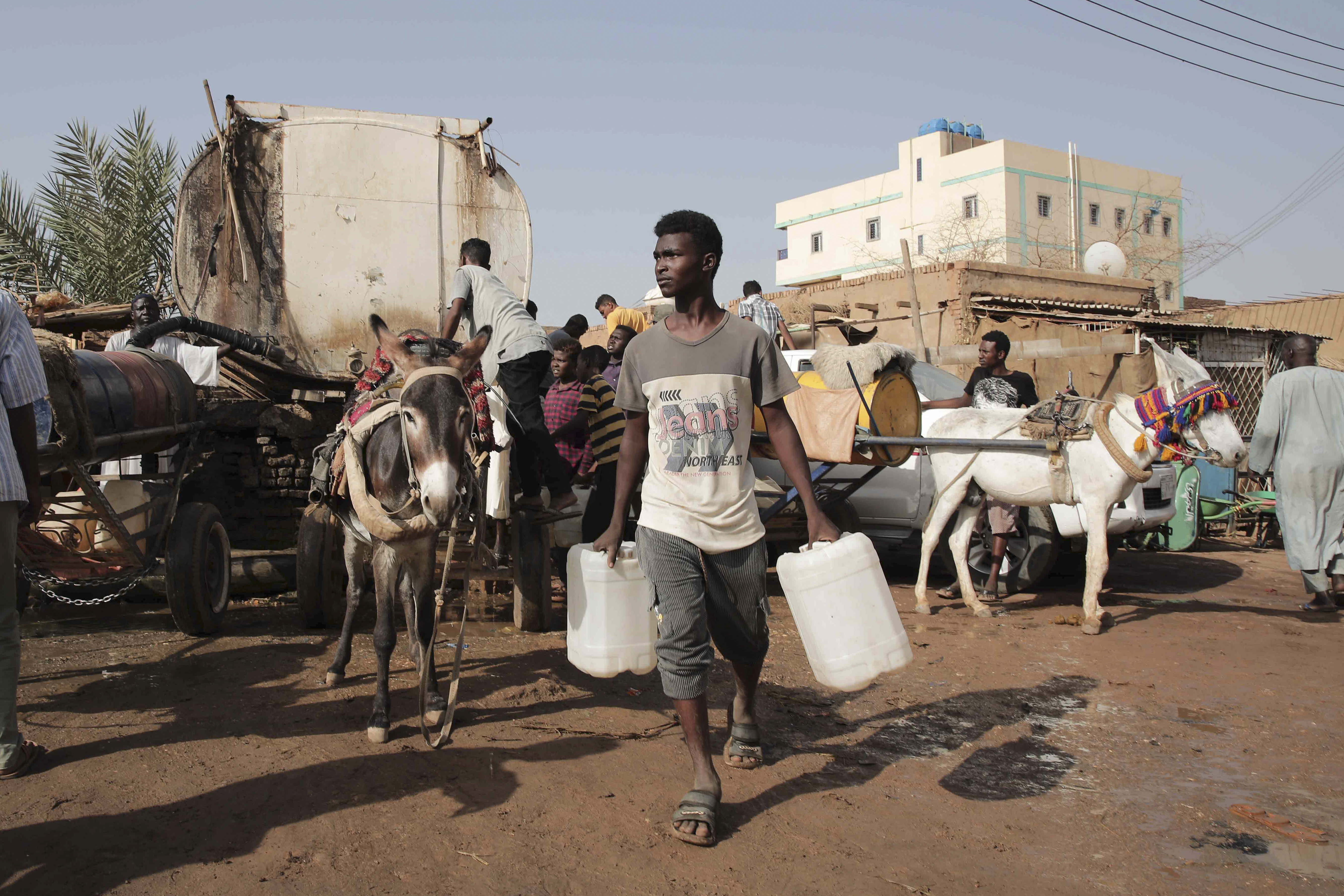 FILE - People gather to collect water in Khartoum, Sudan, May 28, 2023. (AP Photo/Marwan Ali, File)