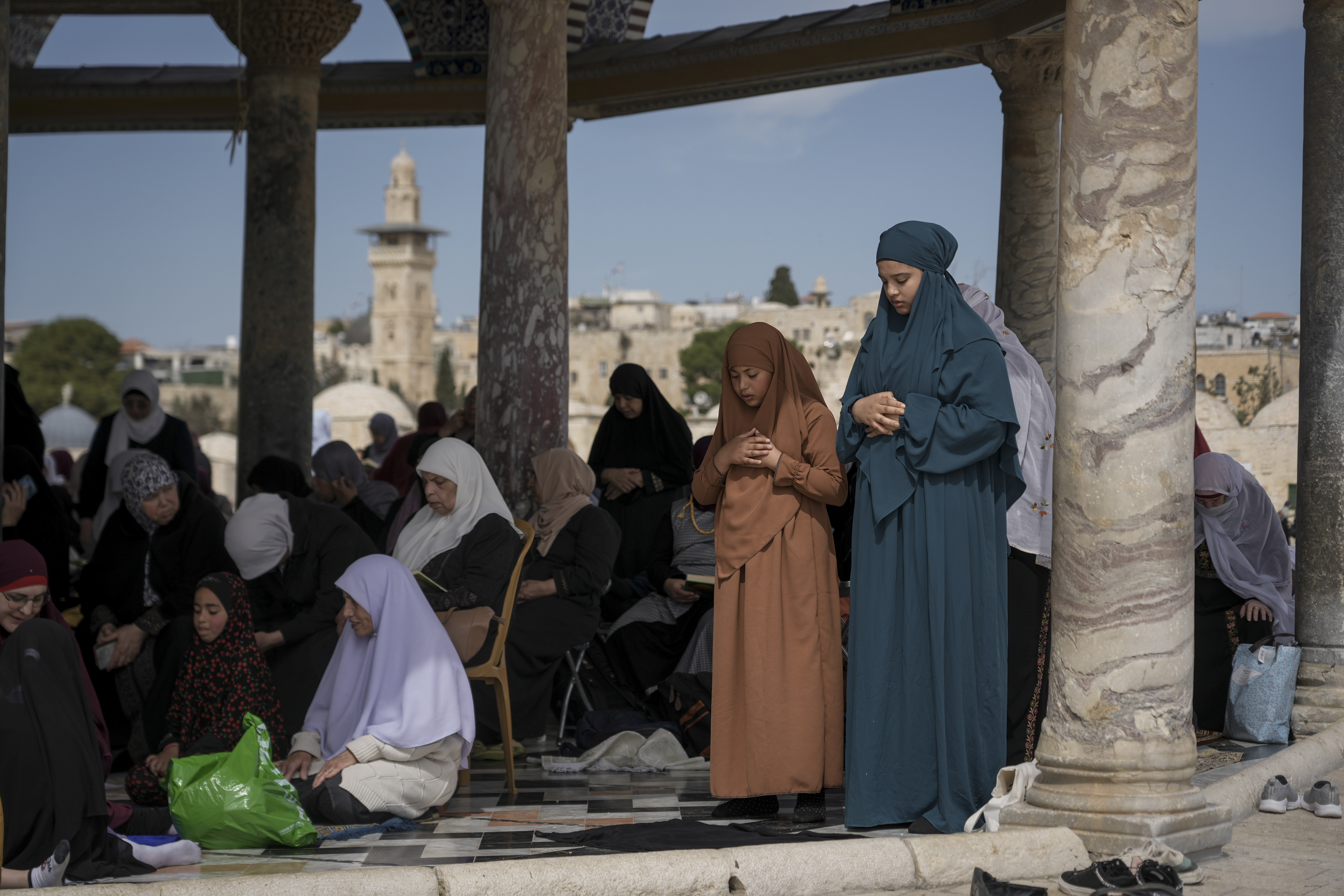 Palestinian women perform Friday prayers at the Al-Aqsa Mosque compound in the Old City of Jerusalem, during the Muslim holy month of Ramadan, Friday, March 14, 2025. (AP Photo/Mahmoud Illean)