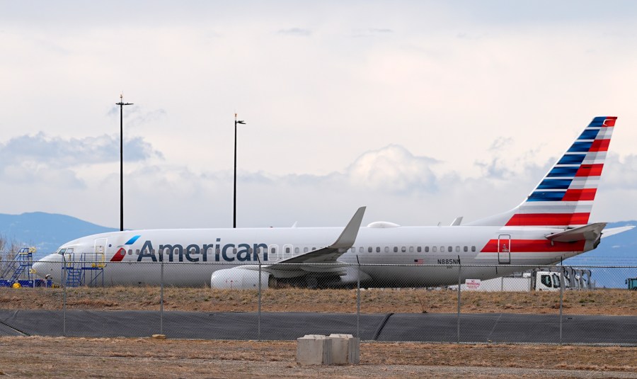 An American Airlines jetliner that caught fire after landing Thursday at Denver International Airport sits near a hangar at the airport Friday, March 14, 2025, in Denver. (AP Photo/David Zalubowski)