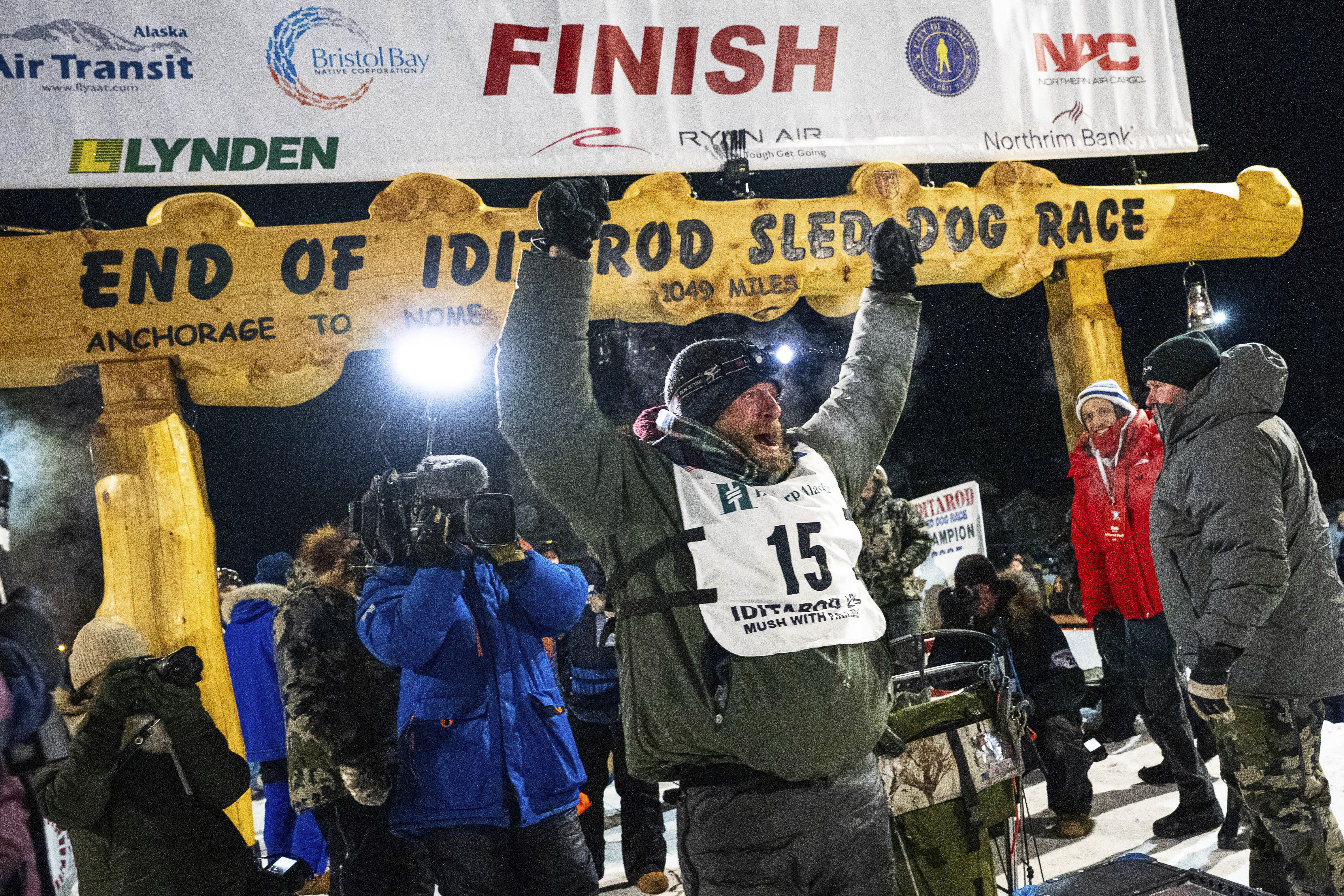 Jessie Holmes celebrates after winning the Iditarod Trail Sled Dog Race early Friday morning, March 14, 2025 in Nome. (Loren Holme/Anchorage Daily News via AP)