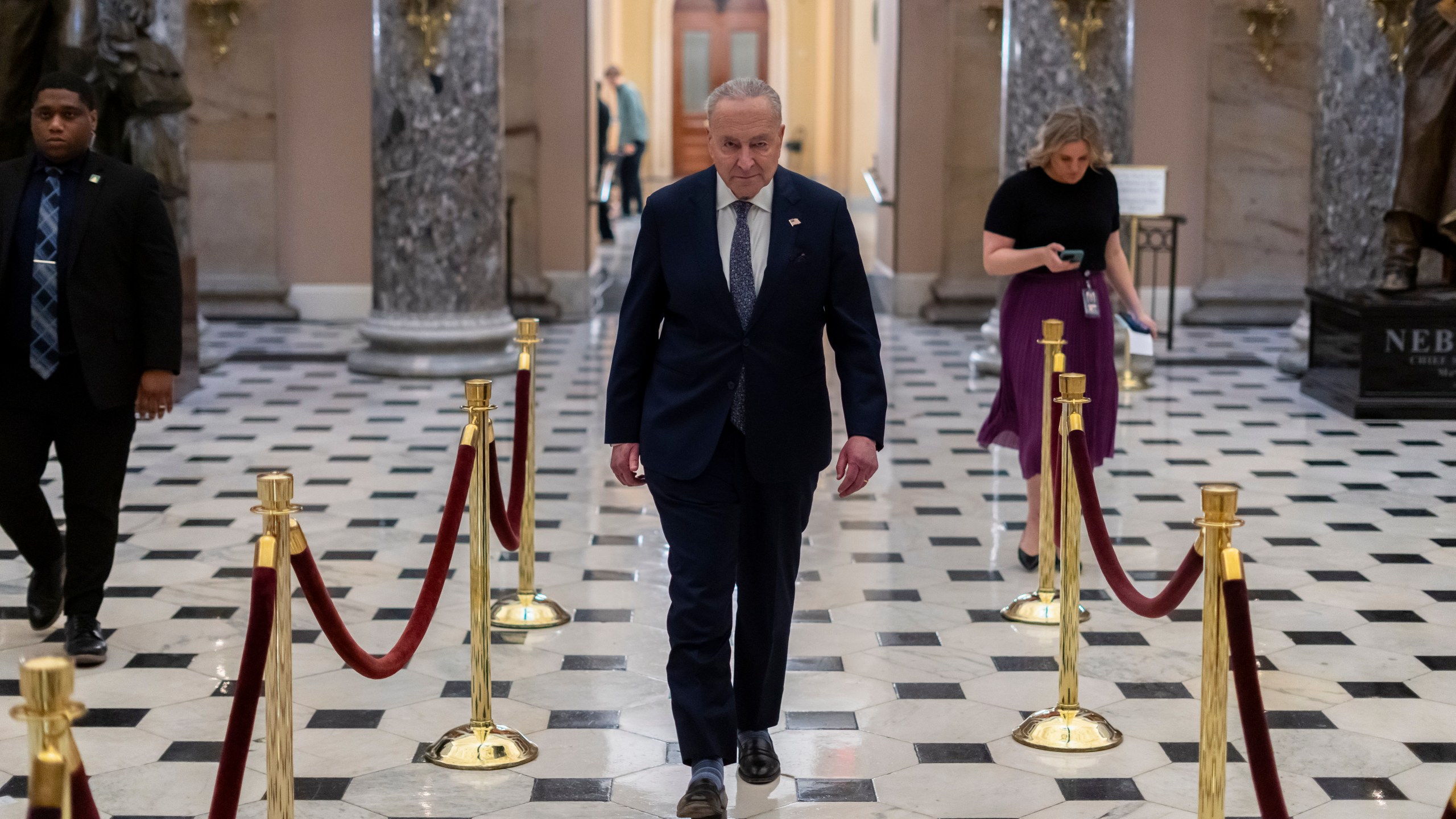 Senate Democratic Leader Chuck Schumer returns after giving a television interview, at the Capitol in Washington, Friday, March 14, 2025. (AP Photo/Ben Curtis)