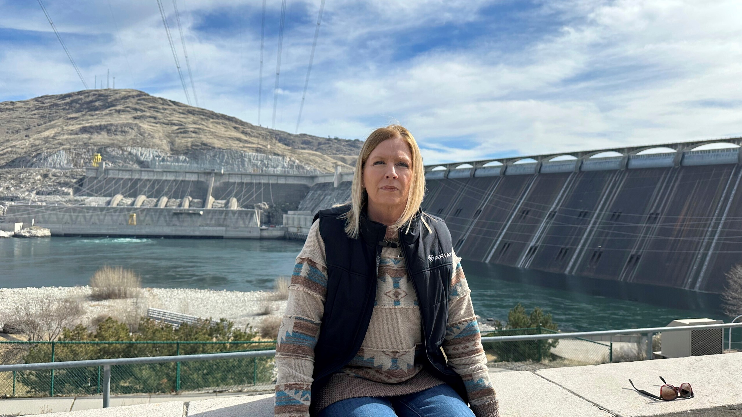 Former Grand Coulee Dam worker, Stephanie Duclos, sits in front of the Grand Coulee Dam on Friday, Feb. 28, 2025 in Coulee Dam, Wash., explaining how she was terminated from her job under the Trump administration’s federal workforce reduction plan. (AP Photo/Martha Bellisle)