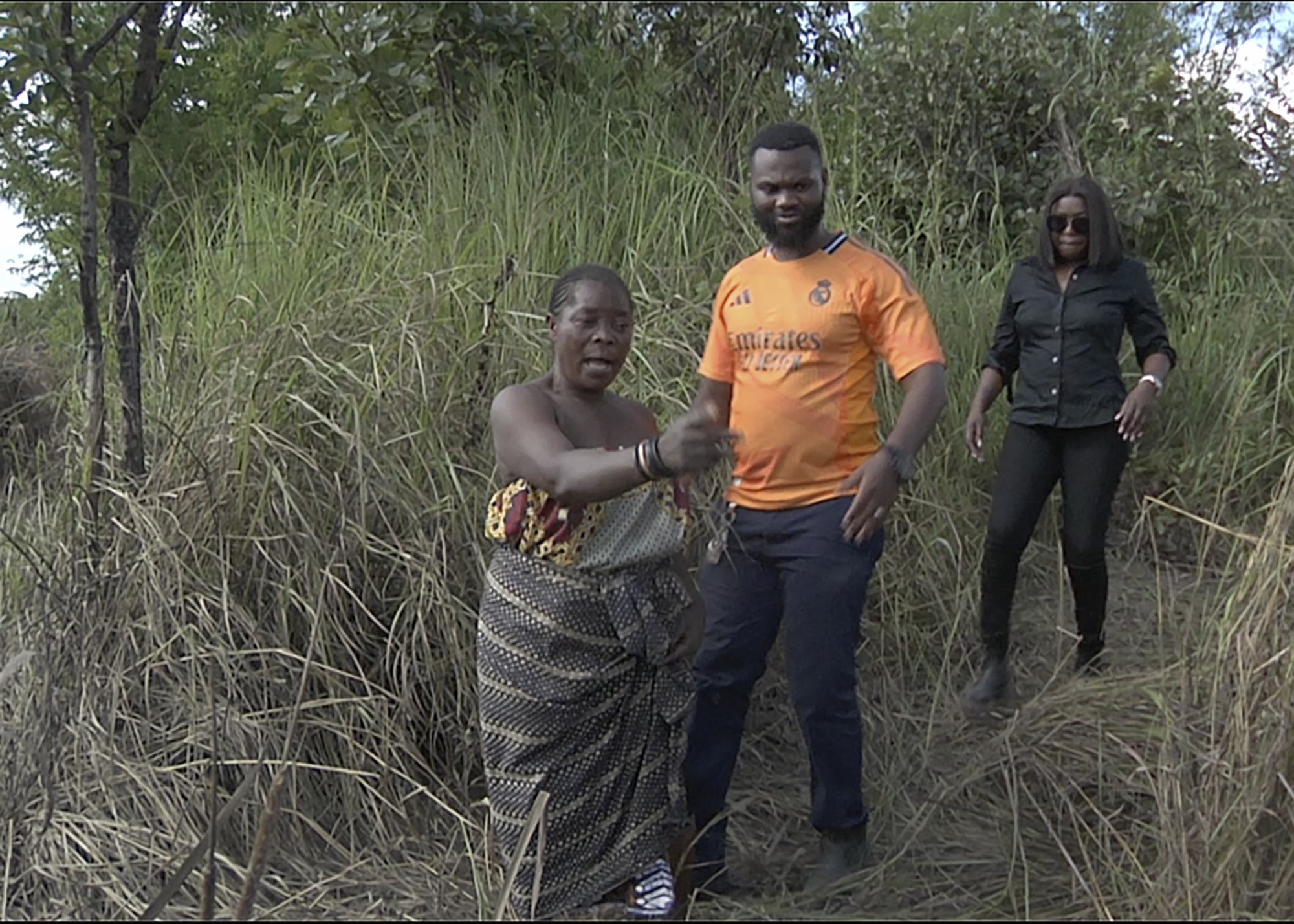 This image taken from video Wednesday, Feb. 19, 2025, shows farmer Juliet Balaya as she surveys the damage to her crop and fishpond caused by a mine waste spill near Kitwe. (AP Photo/Richard Kille )