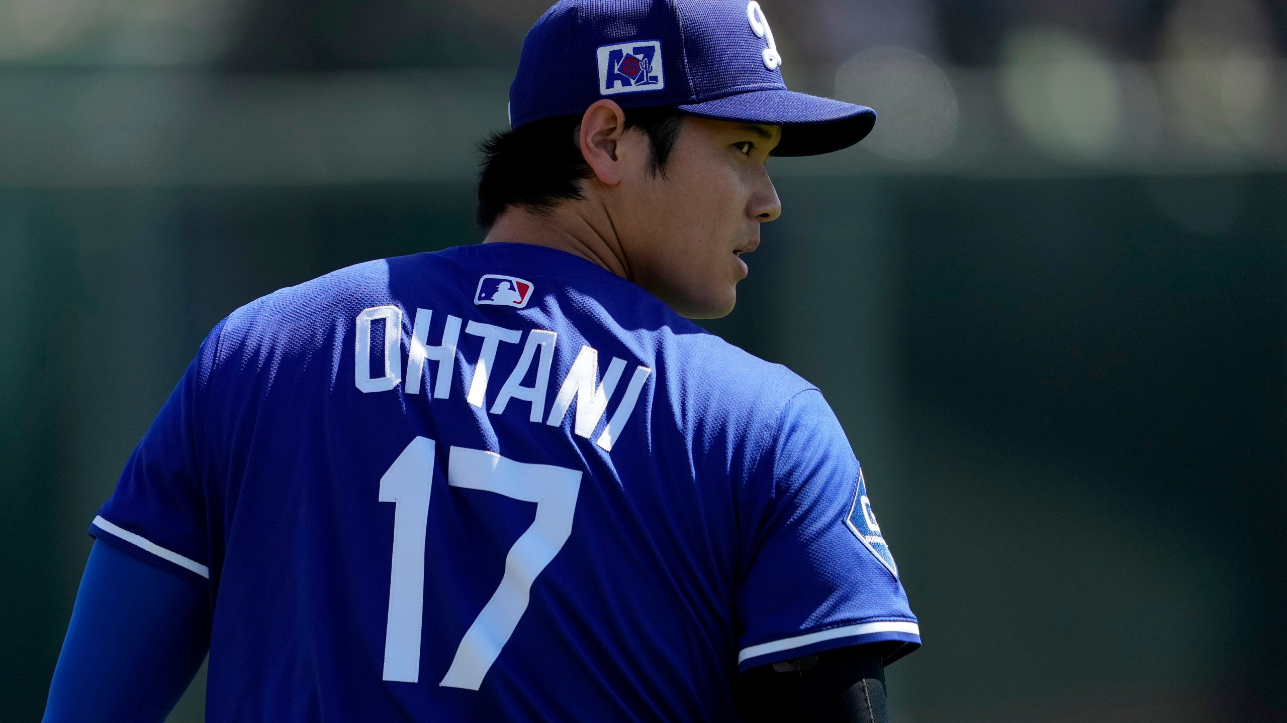 Los Angeles Dodgers' Shohei Ohtani warms up prior to a spring training baseball game against the Arizona Diamondbacks, Monday, March 10, 2025, in Phoenix. (AP Photo/Matt York)