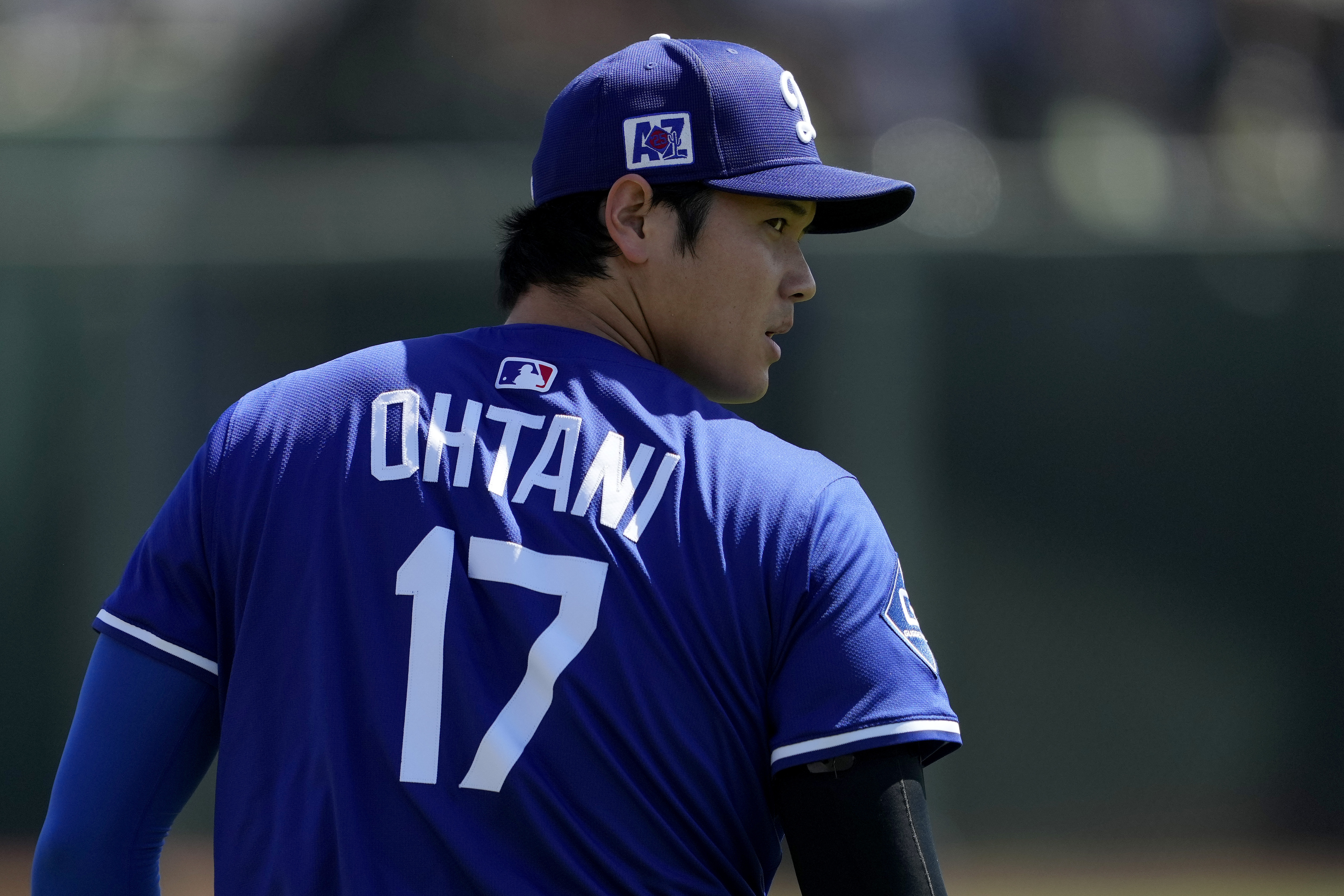 Los Angeles Dodgers' Shohei Ohtani warms up prior to a spring training baseball game against the Arizona Diamondbacks, Monday, March 10, 2025, in Phoenix. (AP Photo/Matt York)