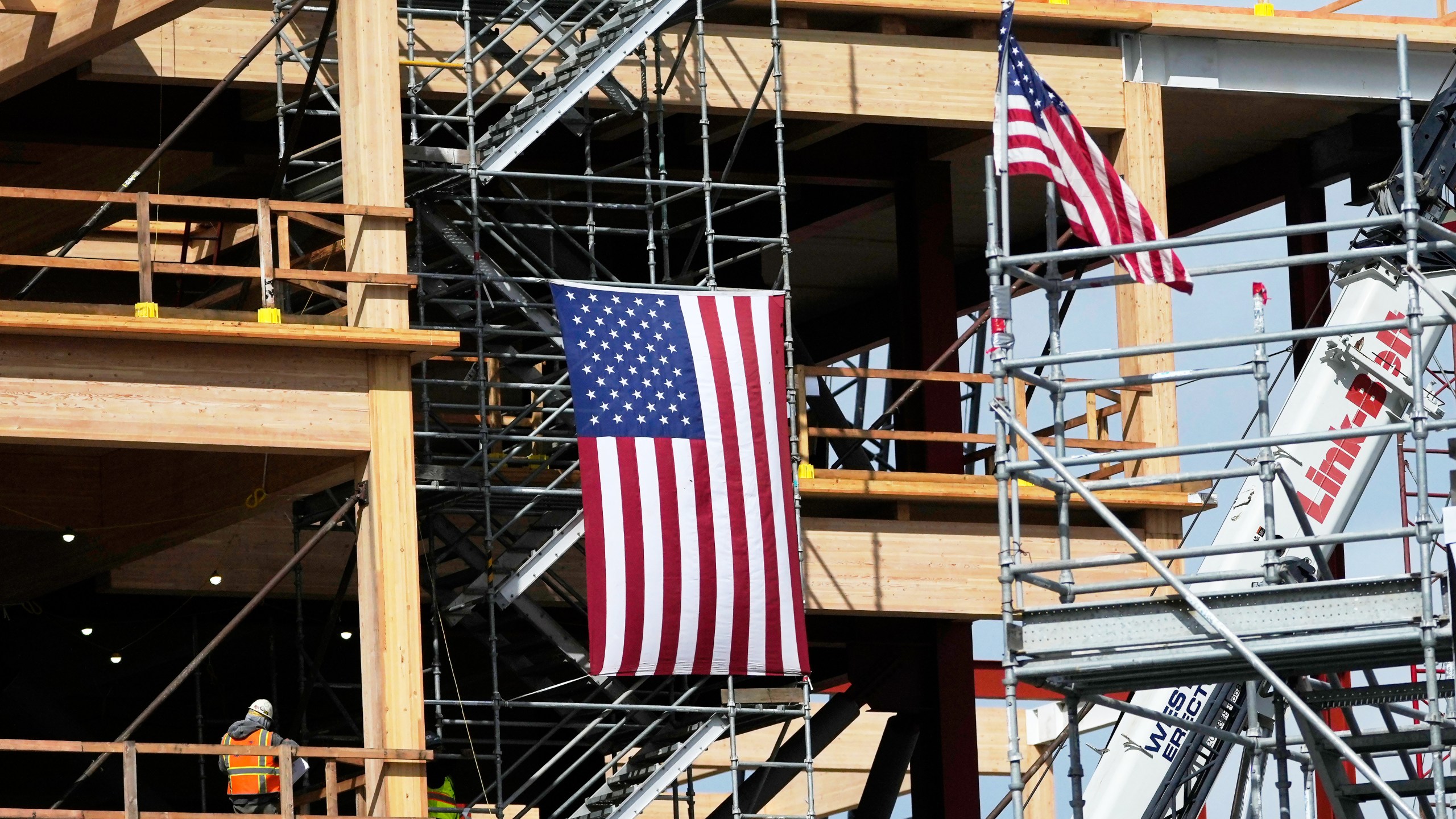 A construction crew works at a site in San Bruno, Calif., Wednesday, March 12, 2025. (AP Photo/Jeff Chiu)