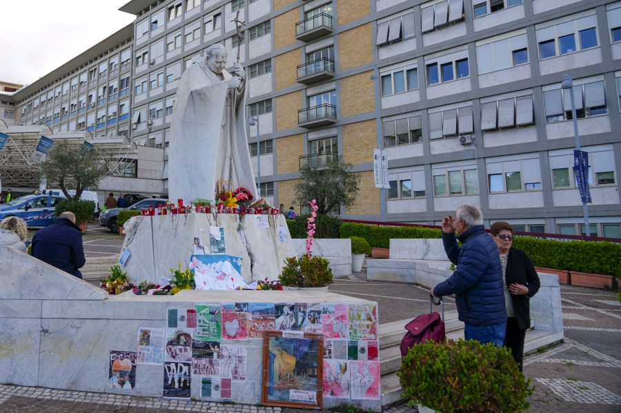 People pray for Pope Francis in front of the Agostino Gemelli Polyclinic, in Rome, Saturday, March 15, 2025, where the Pontiff is hospitalized since Feb. 14. (AP Photo/Andrew Medichini)