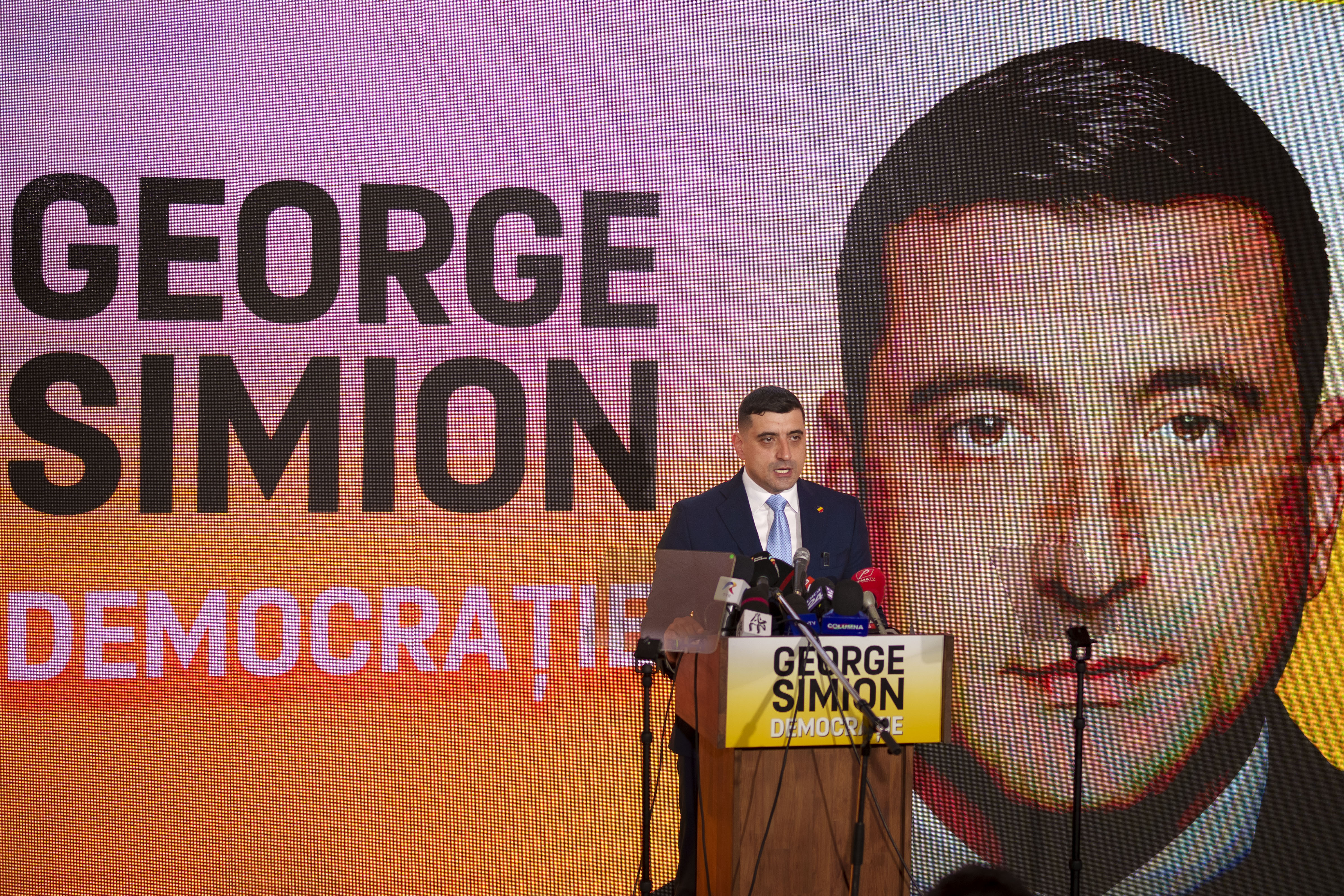 George Simion, the leader of Romania's most popular far-right party, the Alliance for the Union of Romanians (AUR), speaks in Bucharest, Romania, Friday, March 14, 2025, after filing his candidacy to participate in the country's presidential election rerun in May as he seeks to rally nationalist voters in the wake of last year's controversial frontrunner being barred from the race. (AP Photo/Vadim Ghirda)