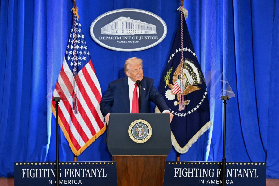 President Donald Trump speaks at the Justice Department in Washington, Friday, March 14, 2025. (Pool via AP)