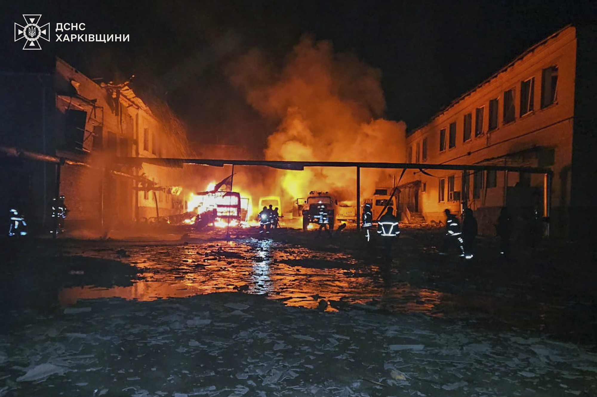 In this photo provided by the Ukrainian Emergency Service, fire engines burn after a Russian drone hit them when firefighters were putting out a fire at a lyceum following Russian drone attack in Bohodukhiv, Kharkiv region, Ukraine, Saturday, March 15, 2025. (Ukrainian Emergency Service via AP)