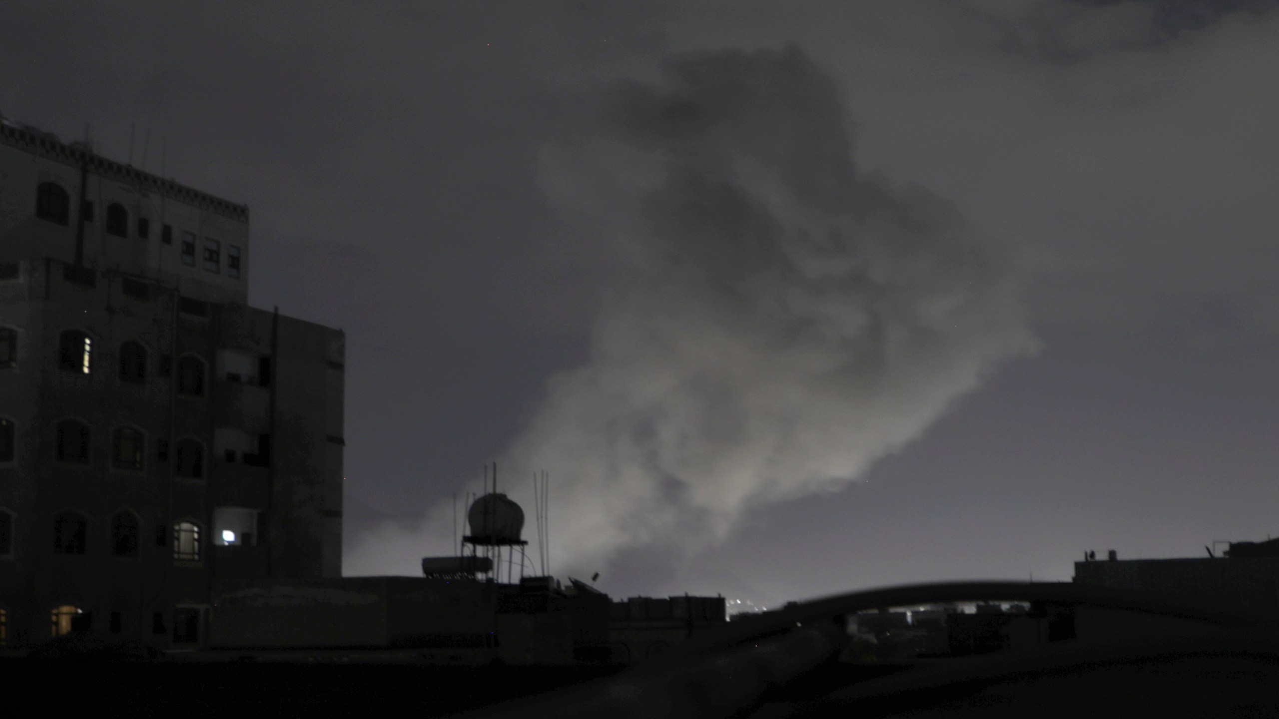 Smoke rises from a location reportedly struck by U.S. airstrikes in Sanaa, Yemen, Saturday, March 15, 2025. (AP Photo/Osamah Abdulrahman