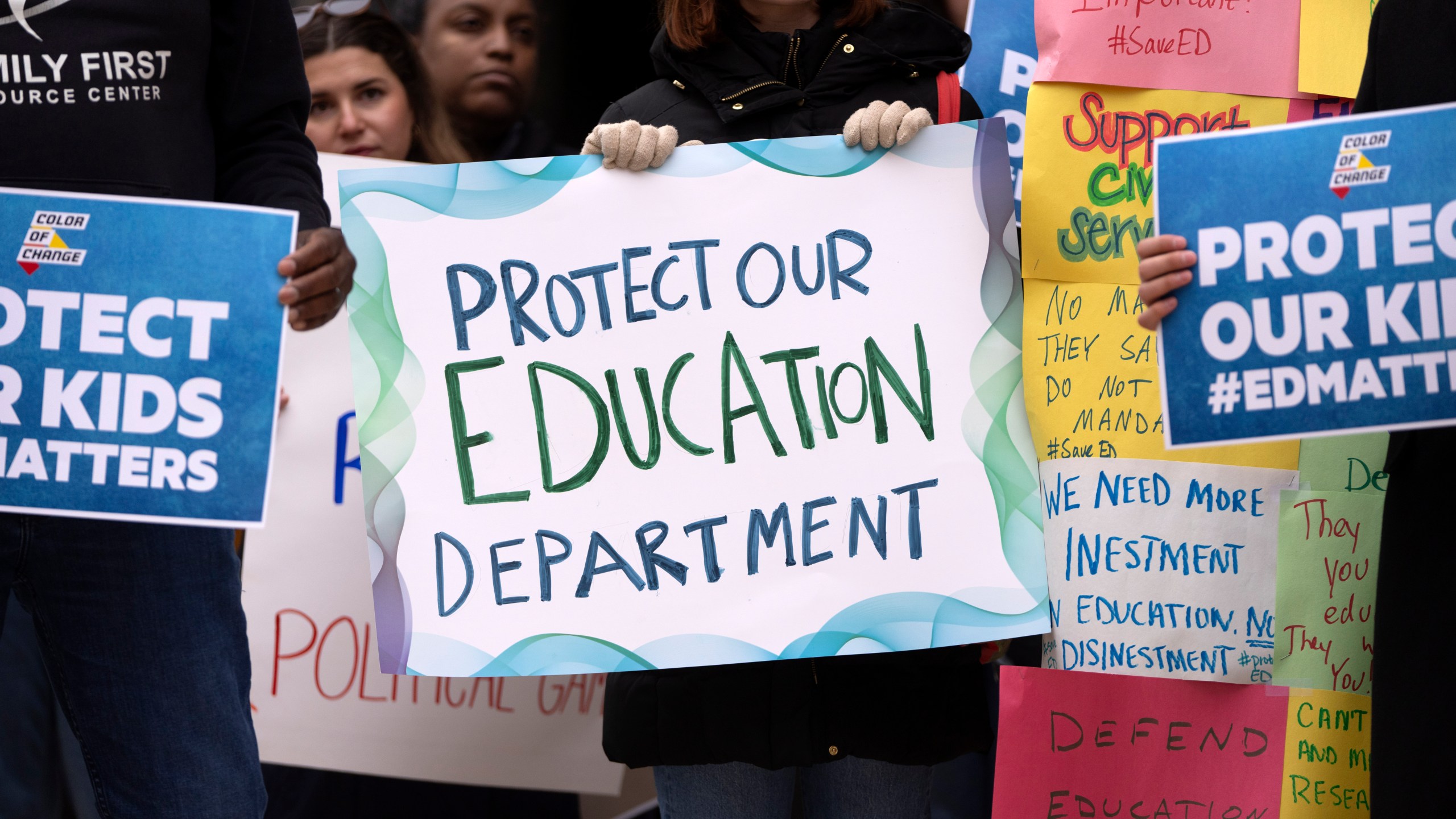 Protestors gather during a demonstration at the headquarters of the Department of Education, Friday, March 14, 2025, in Washington. (AP Photo/Mark Schiefelbein)