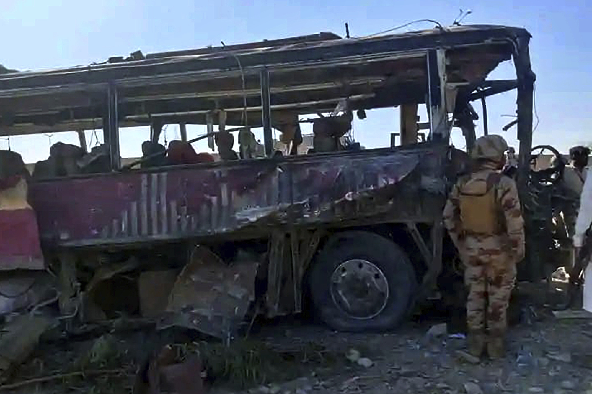 A paramilitary soldier examines a damaged bus at the site of a suicide bombing, in Naushki, a district in southwestern Pakistan's Balochistan province, Sunday, March 16, 2025. (AP Photo)