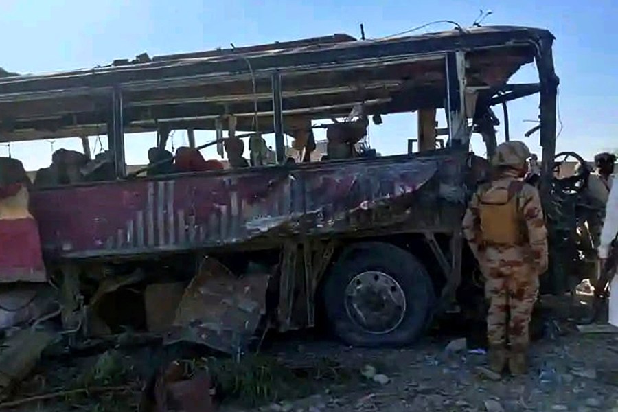 A paramilitary soldier examines a damaged bus at the site of a suicide bombing, in Naushki, a district in southwestern Pakistan's Balochistan province, Sunday, March 16, 2025. (AP Photo)