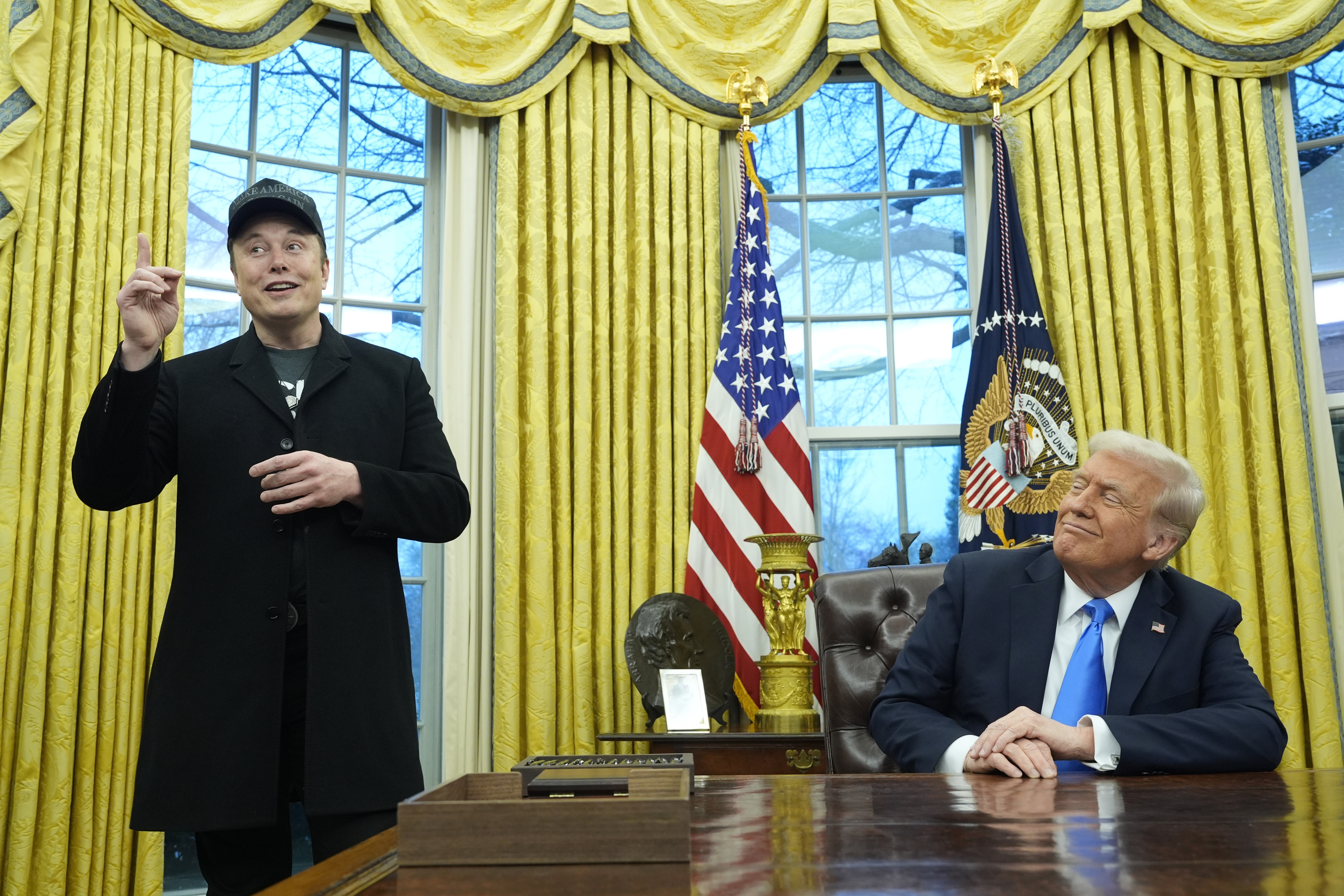 FILE - President Donald Trump listens as Elon Musk speaks in the Oval Office at the White House, Tuesday, Feb. 11, 2025, in Washington. (AP Photo/Alex Brandon, File)